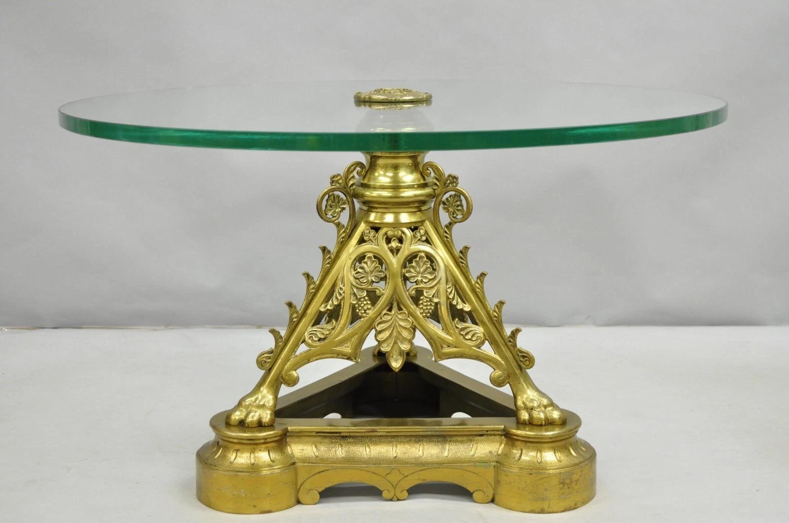 Antique French Empire Renaissance Revival Bronze Paw Foot Pedestal Base Round Glass Top Coffee Table. Item features a triple paw foot pedestal base with leafy scrollwork and 5/8 thick round glass top. Very impressive table. Circa Early 20th Century.