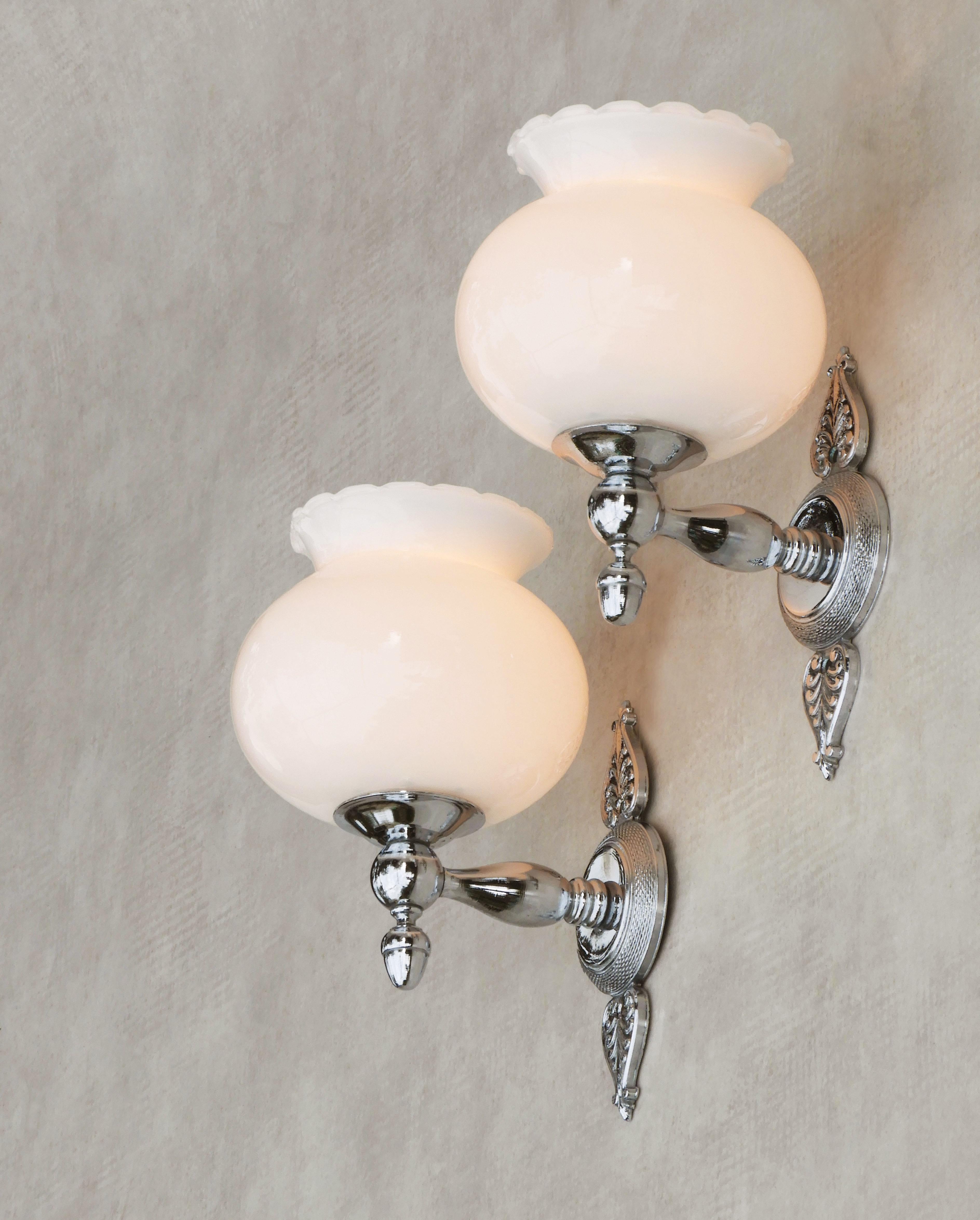 Beautiful pair of Empire-style sconces, France circa 1970. Stylish, French wall lights in chrome and glossy white opaline glass, a sophisticated modern take on a timeless classic design. Well-made, good-quality lights, perfect for either side of a