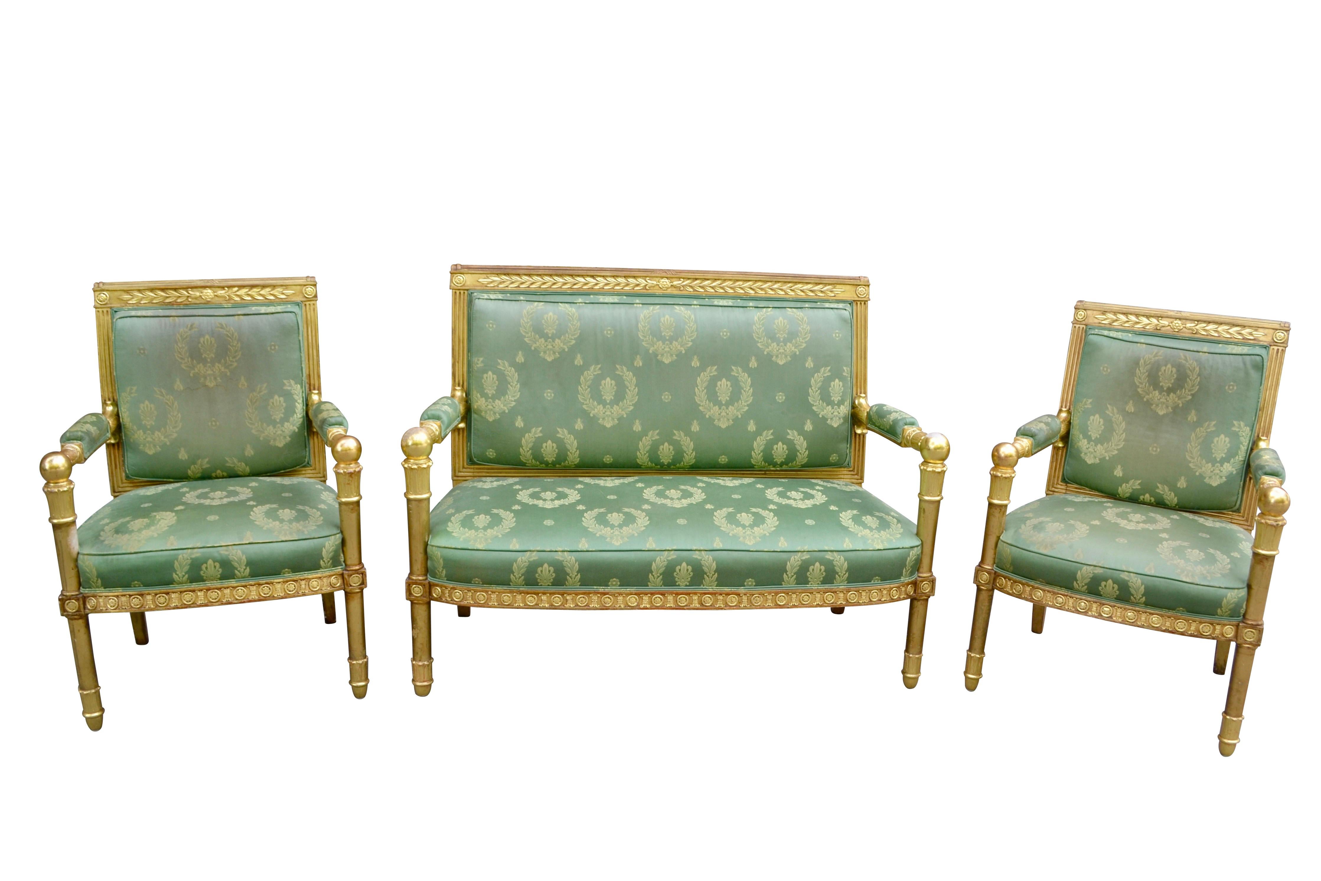 This three piece  early 19 Century  salon set  features finely carved gold leaf gilded frames  accented by  rosettes palmettes and acanthus characterizing most French Empire furniture and Decorative Arts. . While the set isn't stamped, the designs
