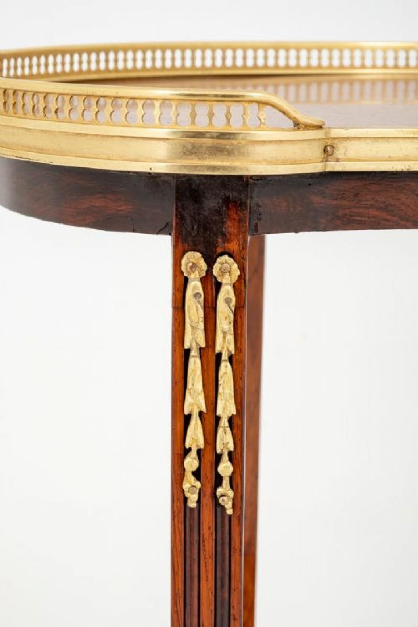 Very Pretty French side table.
This table having shaped and fluted legs with cast brass decoration.
19th century
The two shelves of the table featuring cross banding and floral marquetry inlays.
The top of the table having a cast brass