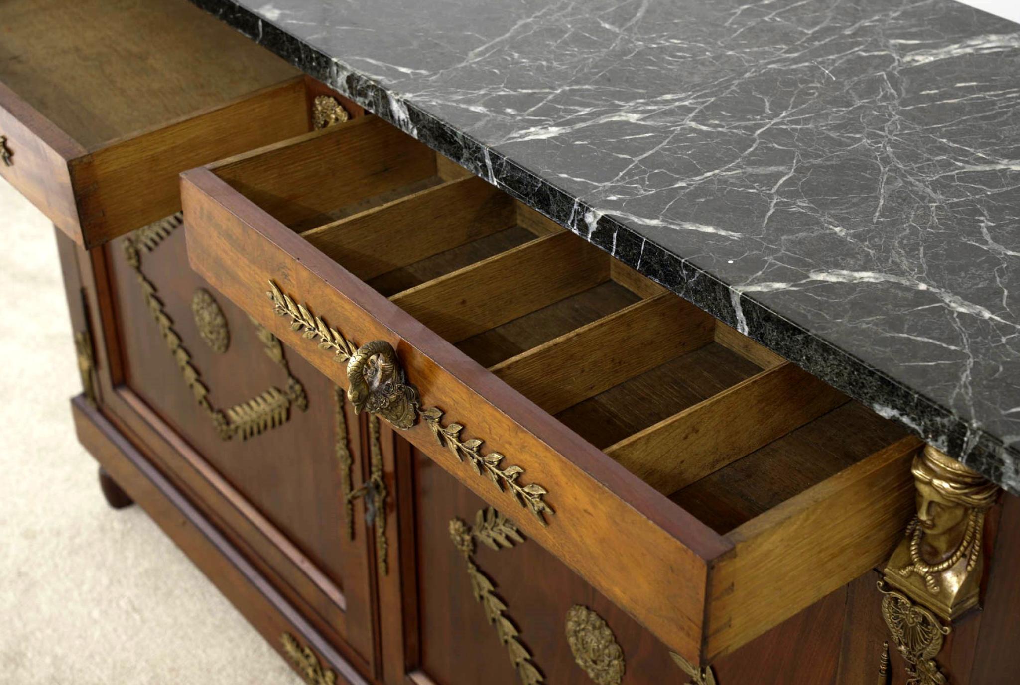 You are viewing a gorgeous French Empire side cabinet or sideboard
Crafted from mahogany with original gilt mounts
Mounts include pharaoh heads to either side and acanthus leaf motifs
Gilt handles also show elegant swan heads with bent necks
Two