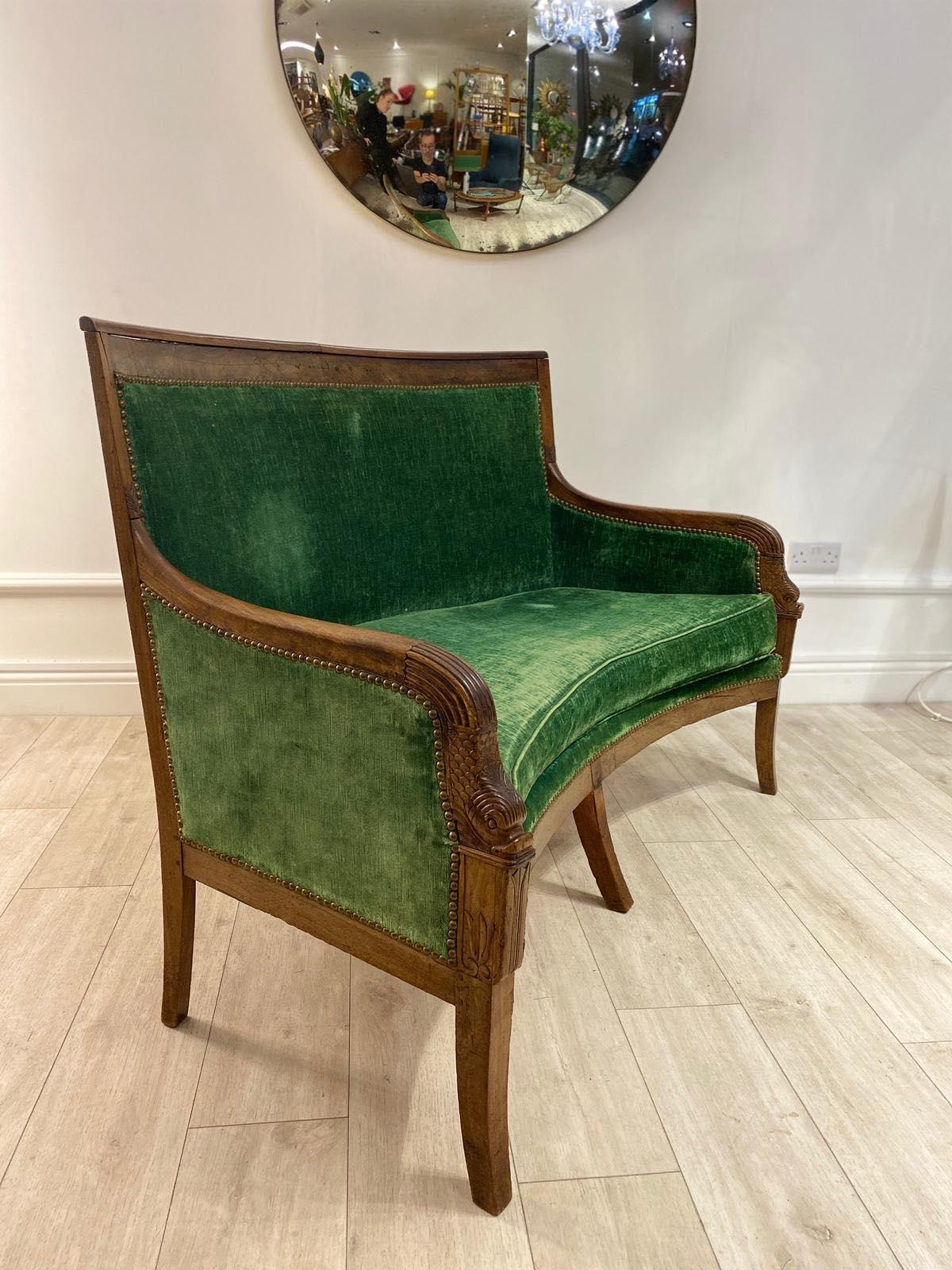 This is a beautiful French Empire two-seat sofa in its original moss green velvet upholstery with mahogany frame and carved dolphin arms. 

Beautiful piece in its original unrestored condition. 

  