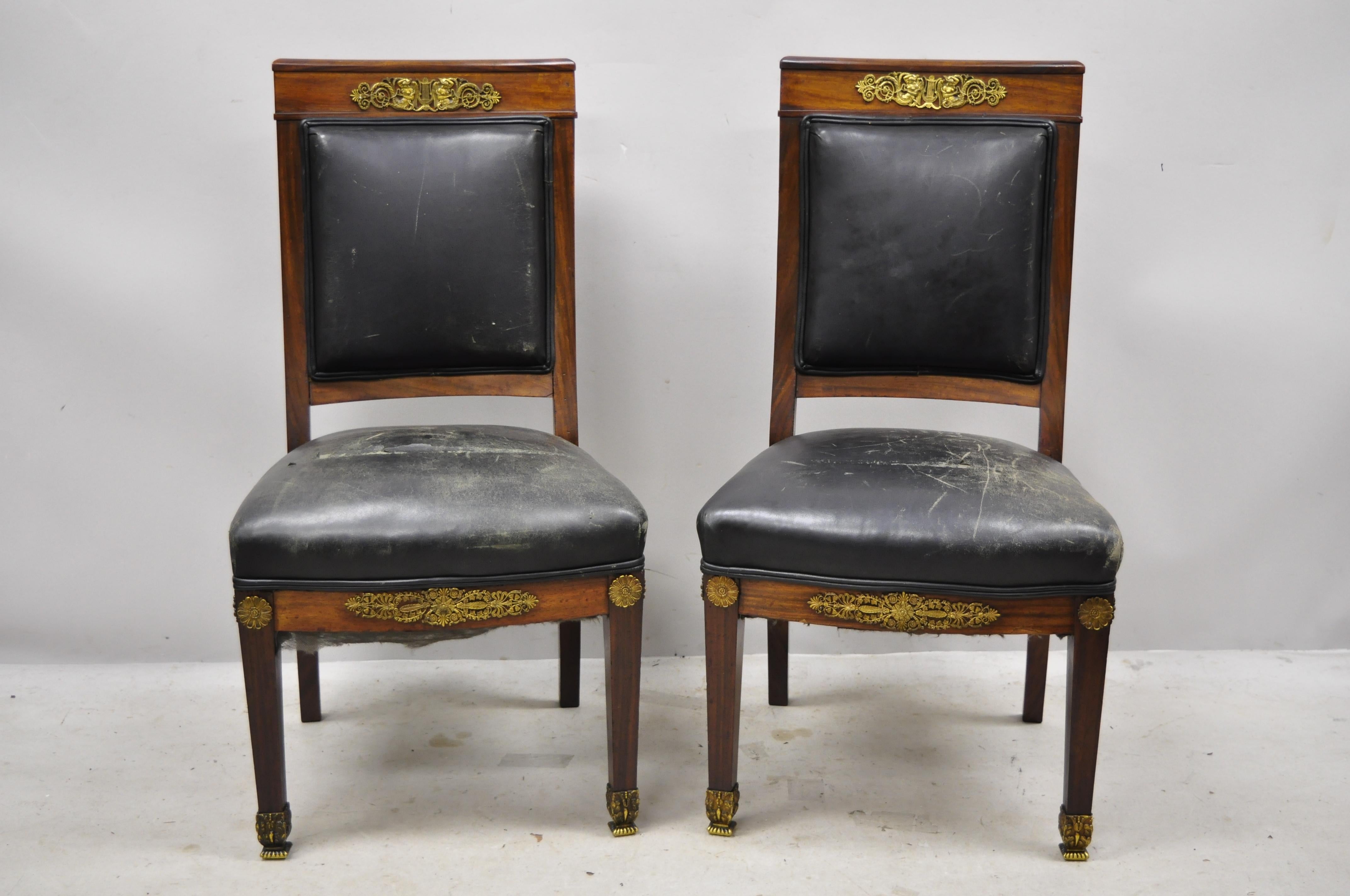 Antique French Empire solid mahogany Regency side chairs with figural bronze ormolu - a pair. Item features finely cast ornate bronze ormolu, slightly curved backrest, solid wood frames, beautiful wood grain, very nice antique pair, quality French