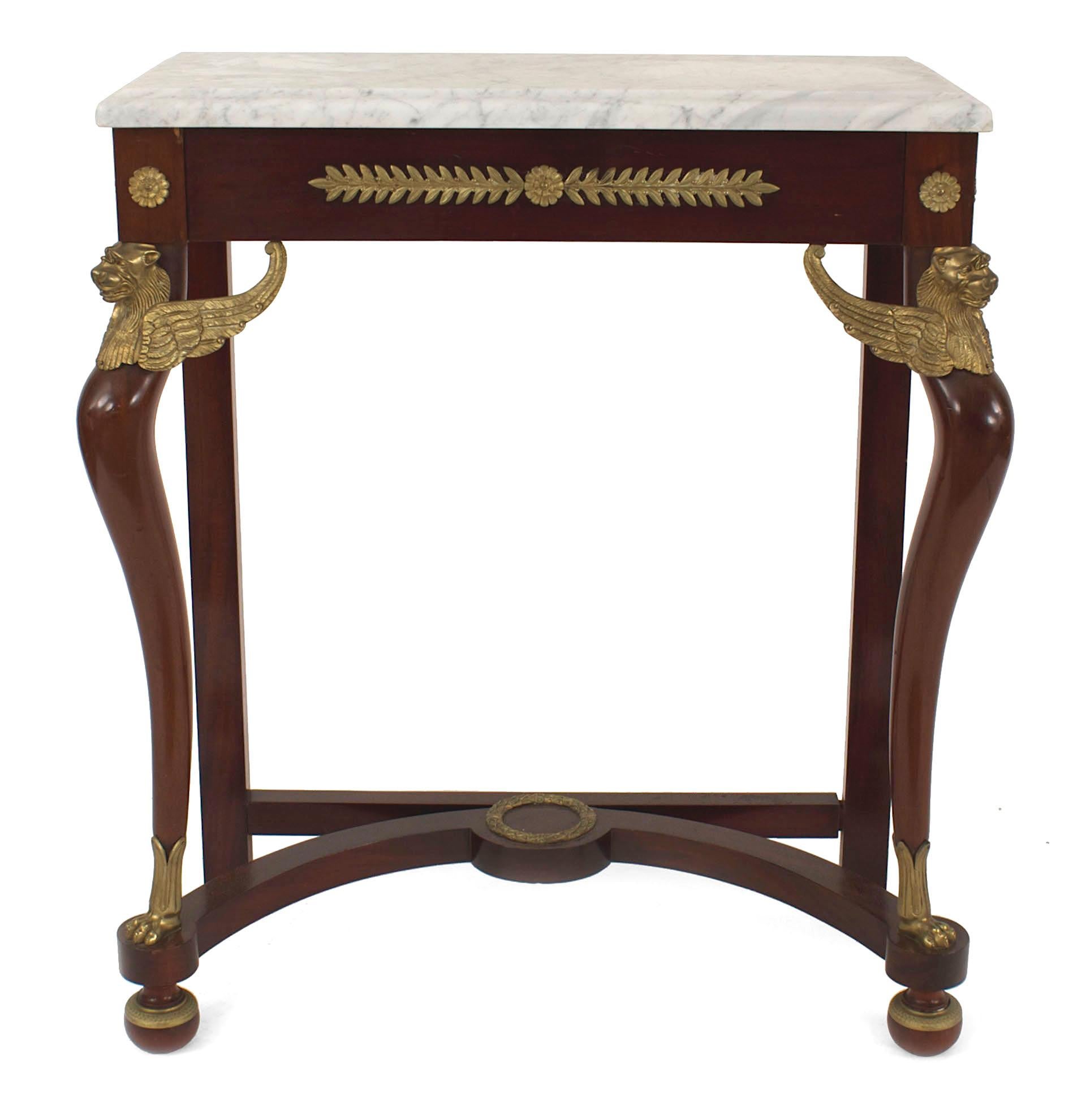 French Empire style (19th-20th century) mahogany console table with a stretcher and gilt bronze trim with a green rectangular marble top.
 