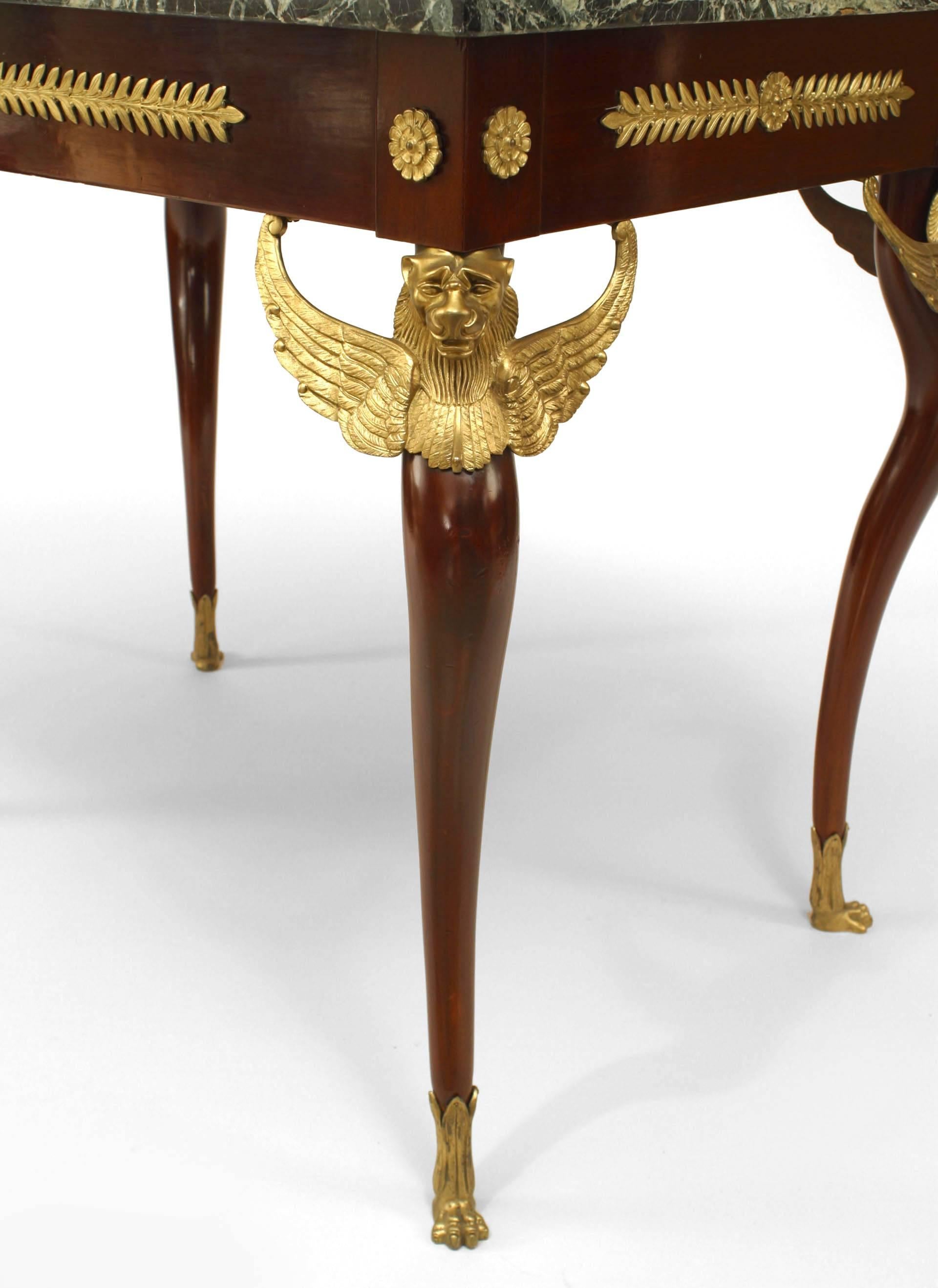 French Empire-style (19th Century) mahogany end/center table with bronze trim and winged griffins on legs with a green rectangular marble top.
