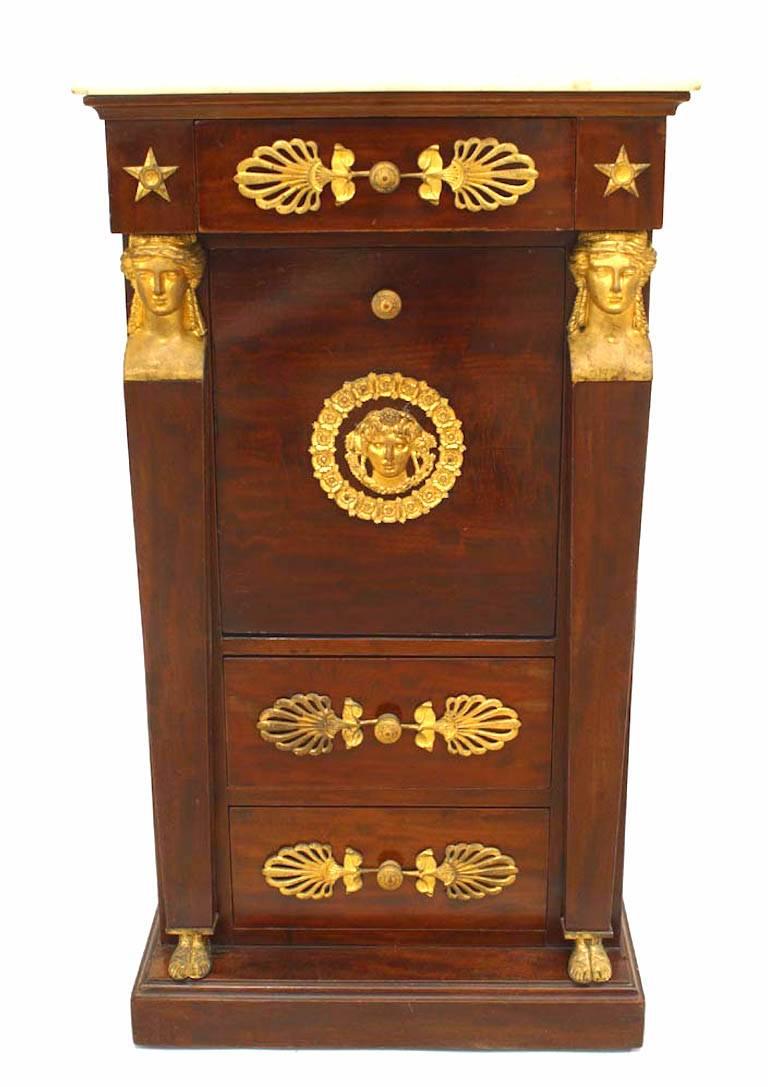 French Empire style (19th Century) mahogany small commode with bronze heads and trim with three drawers, single door, and white marble top.
 