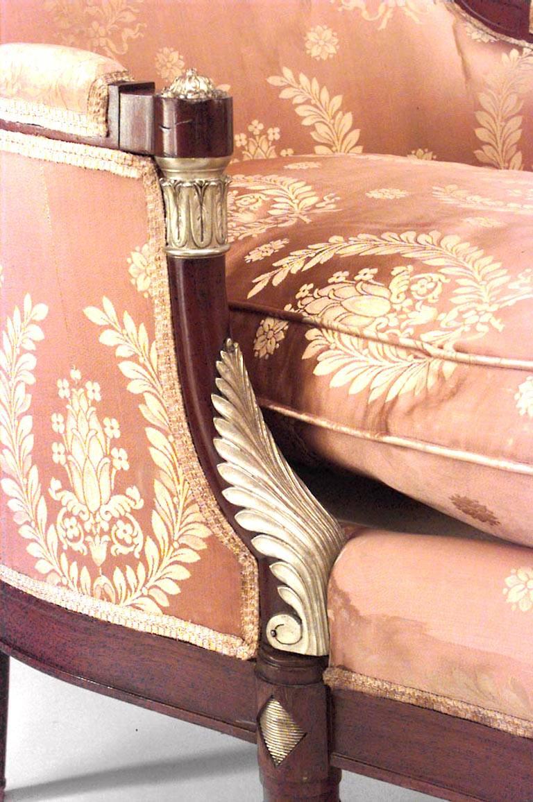 French Empire-style (19th Century) mahogany chaise with bronze trim and large pink and gold cushion upholstery
