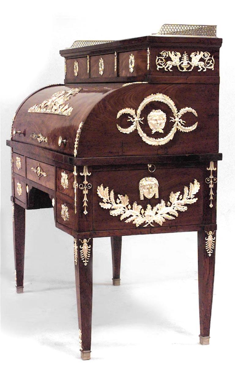 French Empire style (19th Century) mahogany roll top desk with bronze trim.
