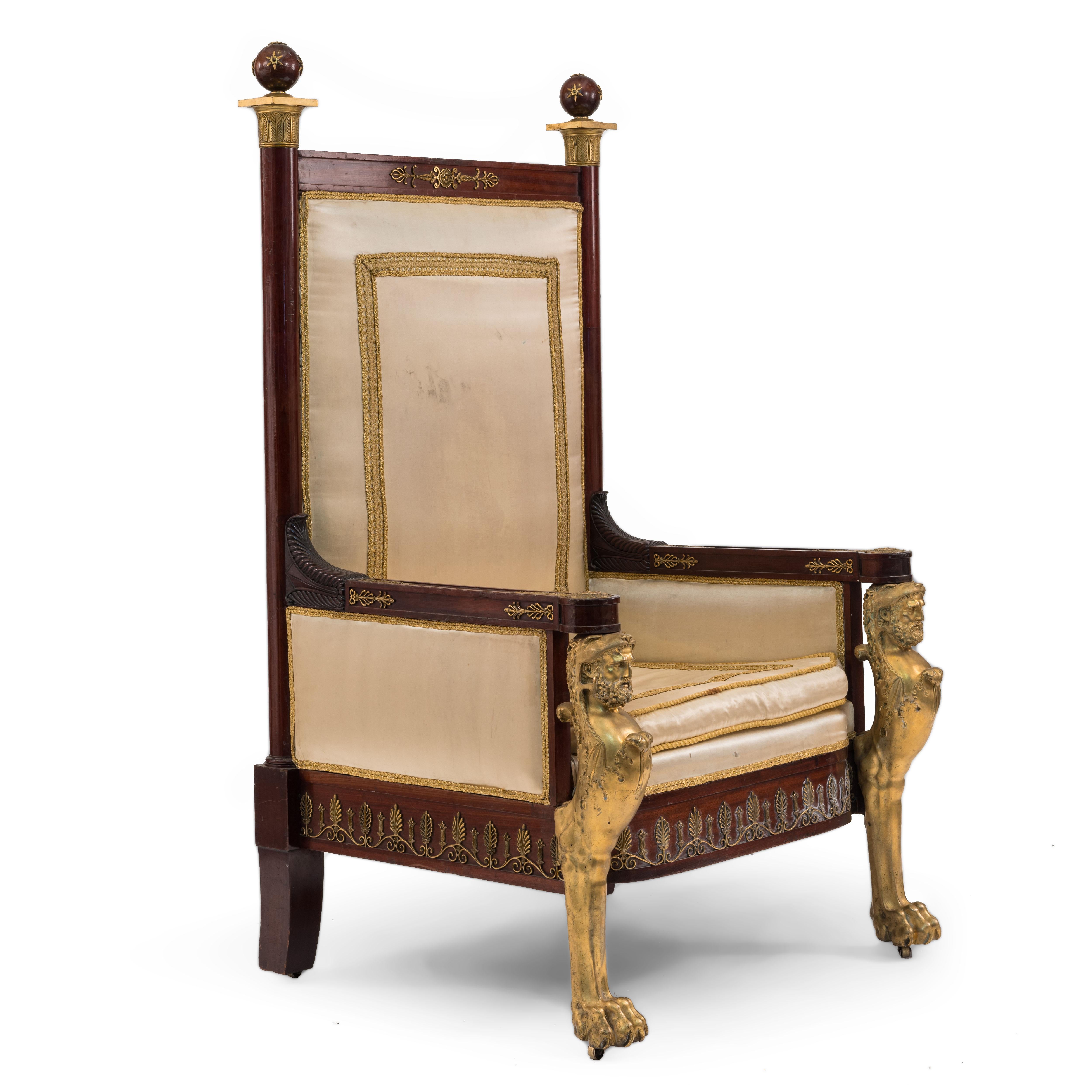 French Empire style 19th Century mahogany throne chair with bronze dore figural front legs and trim with eggshell upholstery.

  