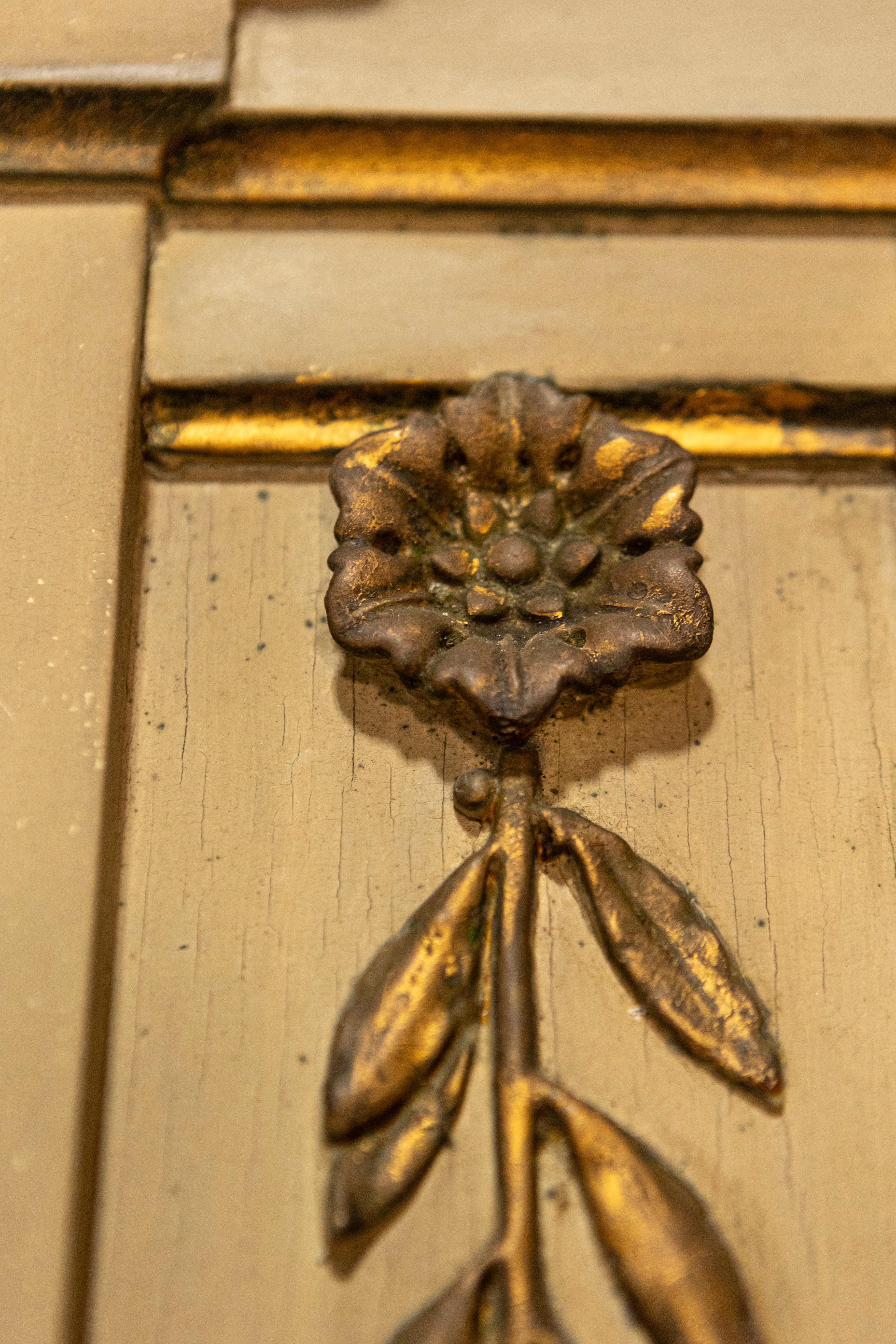 A French Empire style beige painted trumeau mirror from the 20th century with gilded décor. This exquisite French Empire style trumeau mirror from the 20th century is a testament to elegant design and refined craftsmanship. The mirror features a