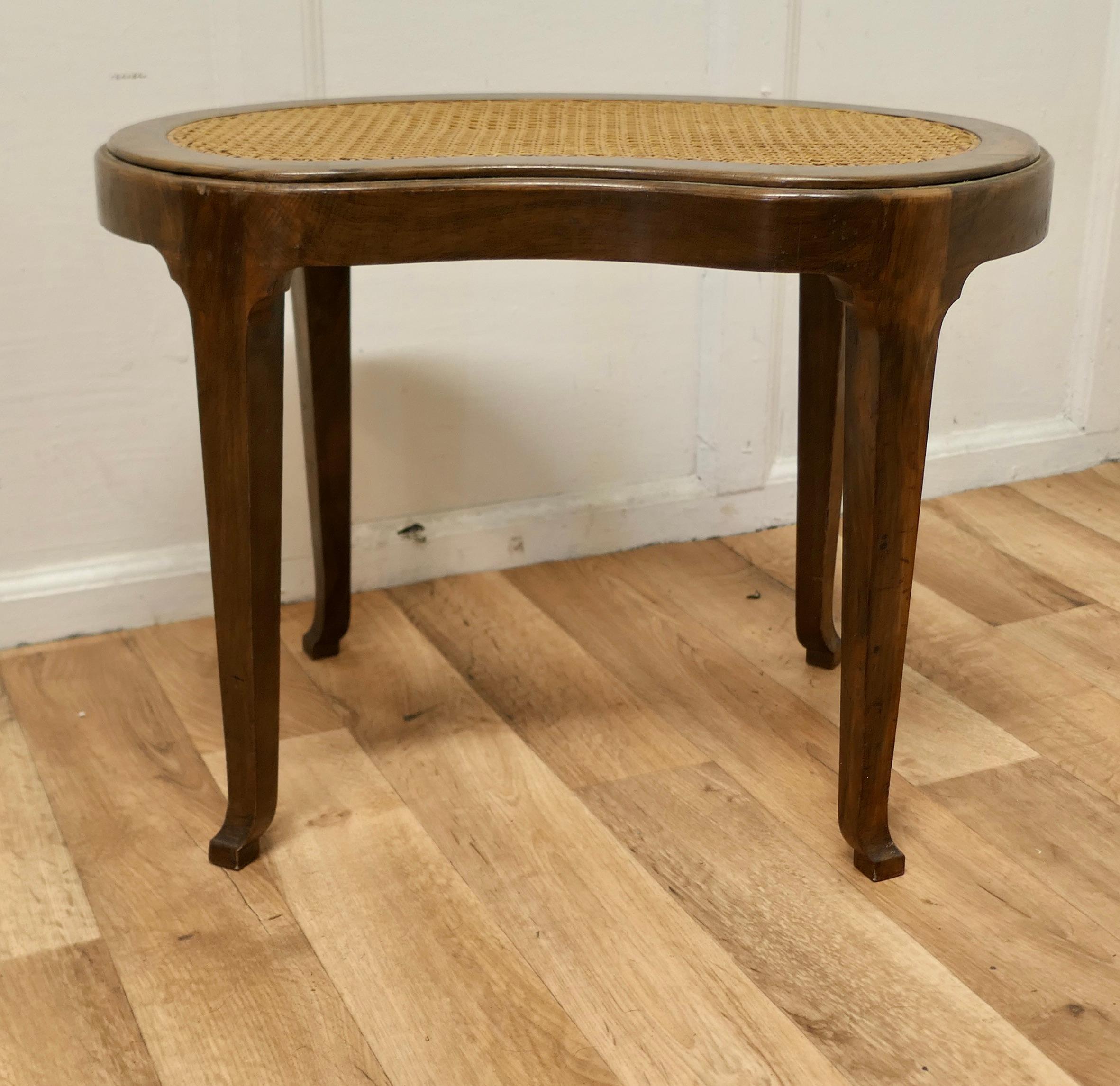 French Empire style Bergère kidney shaped stool.

This is a charming French empire style walnut stool, the stool has a charming golden colour and a very attractive shape, the seat is made with flat cane often known a bergère 
This is a dainty