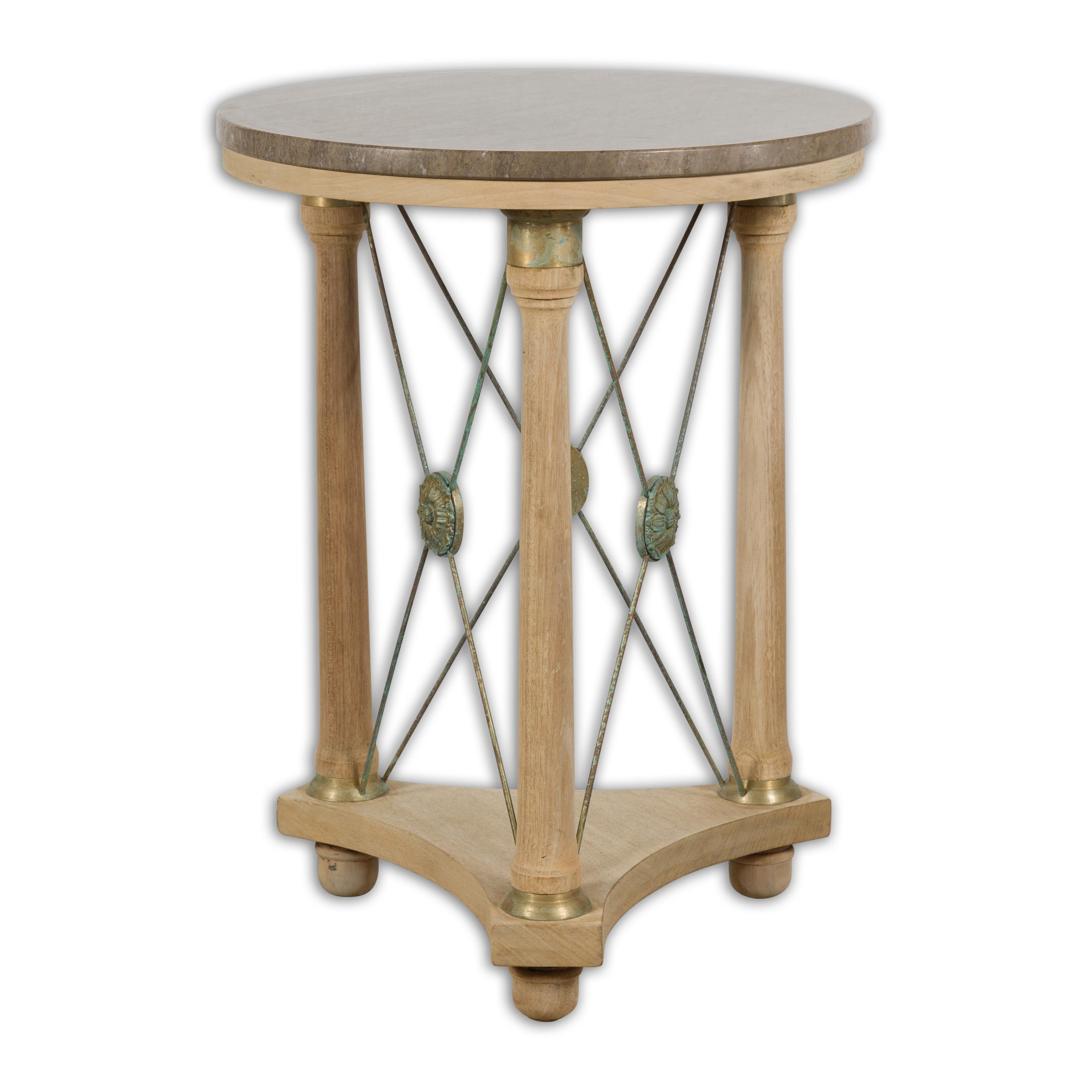 A French Empire style bleached wood side table from the 20th century with round marble top, three columns legs and bronze medallions. Elegant and timeless, this French Empire style bleached wood side table from the 20th century features a round