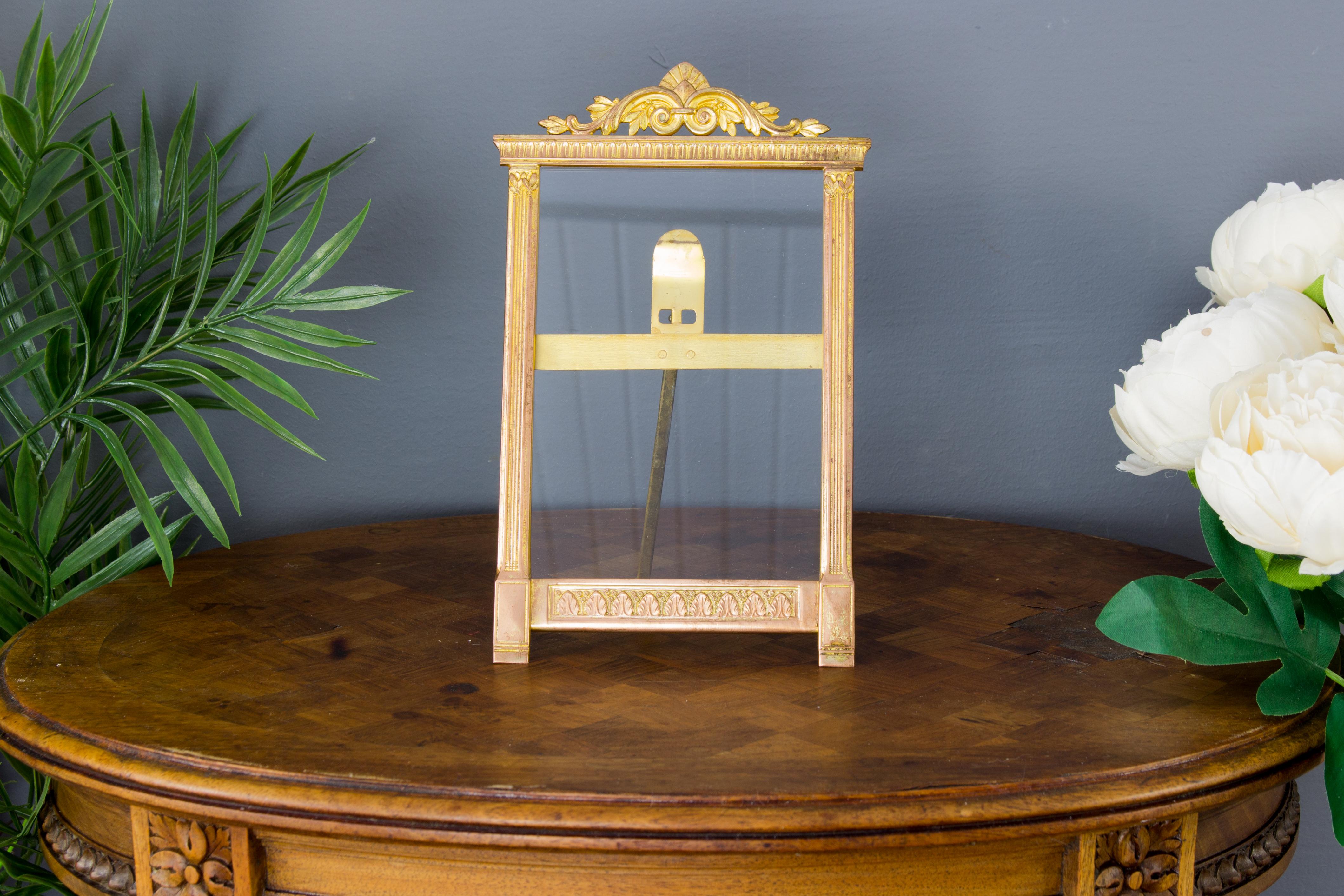 This adorable rectangular frame features brass details in leaf motifs, glass and an easel back.
Dimensions: height 20.5 cm / 8.07 in; width 13.5 cm / 5.31 in; depth 1 cm / 0.39 in.