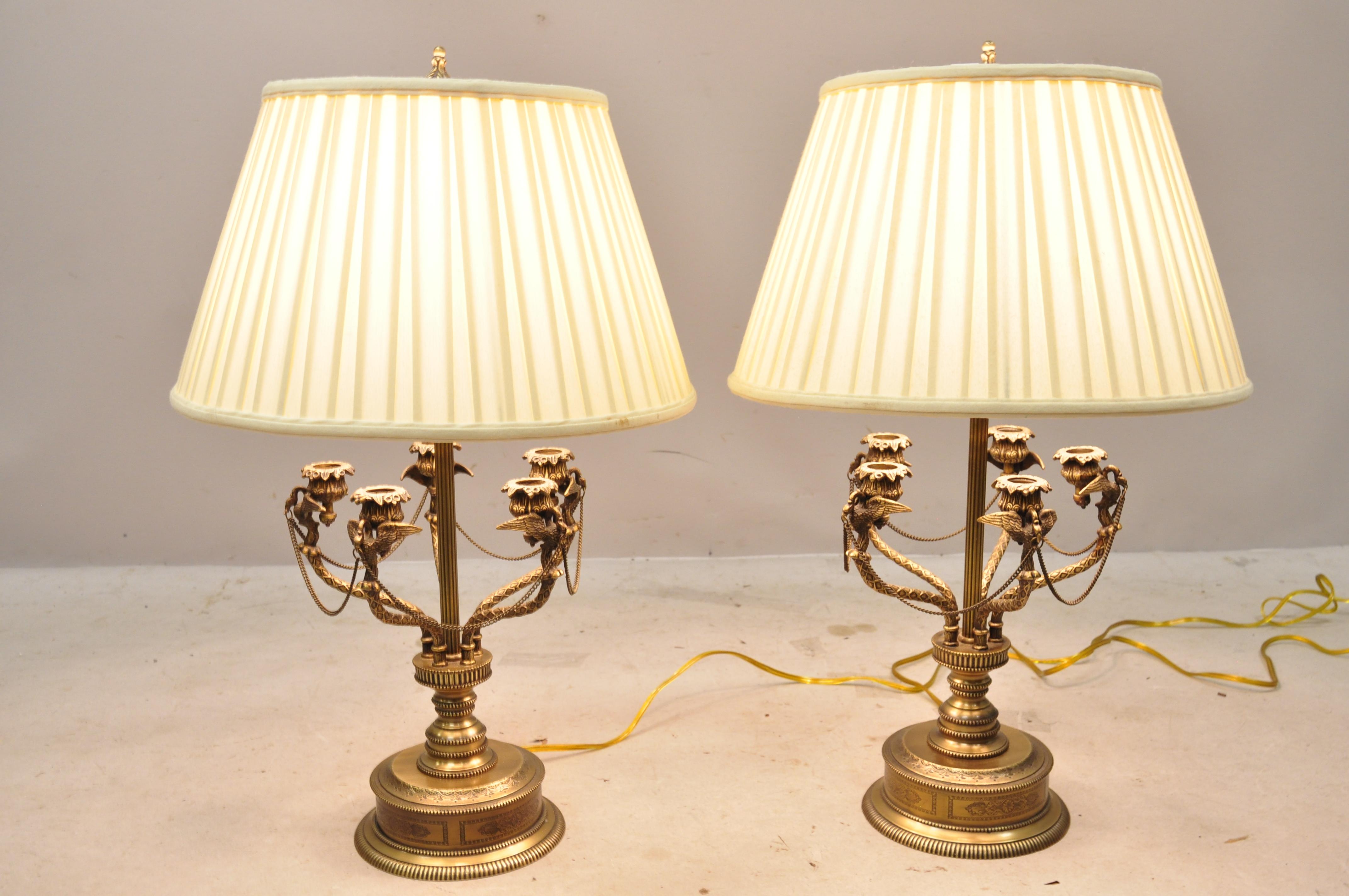 French Empire style brass figural bird swan candelabra table lamps - a pair. Item features winged swan figures, 5 candleholders, original shades, chain accents, ornate engraved details, single light socket, 3-way sockets, circa mid-late 20th