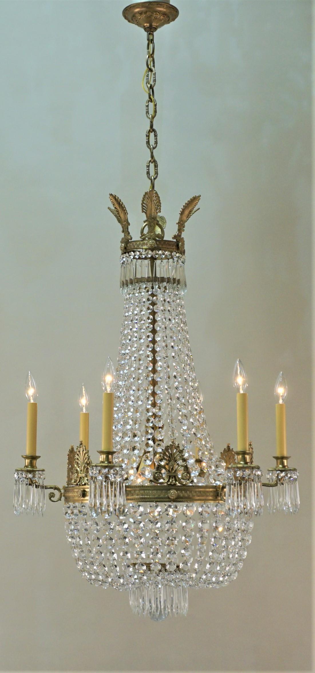 French Empire style chandelier with beautiful detail crafted bronze and hand polished crystal.
Total of 9-light 60 watts max each
Measurement: 25
