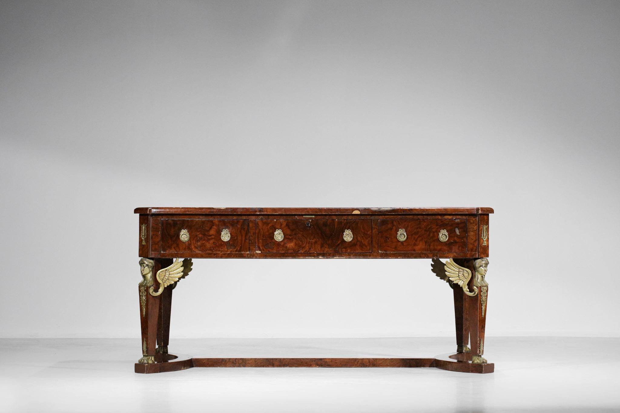 Very decorative French desk in the empire style. Structure in solid mahogany and veneered, it is composed of an empire green leather under hand, three drawers with double handles and decorated with many gilded bronze elements typical of the empire