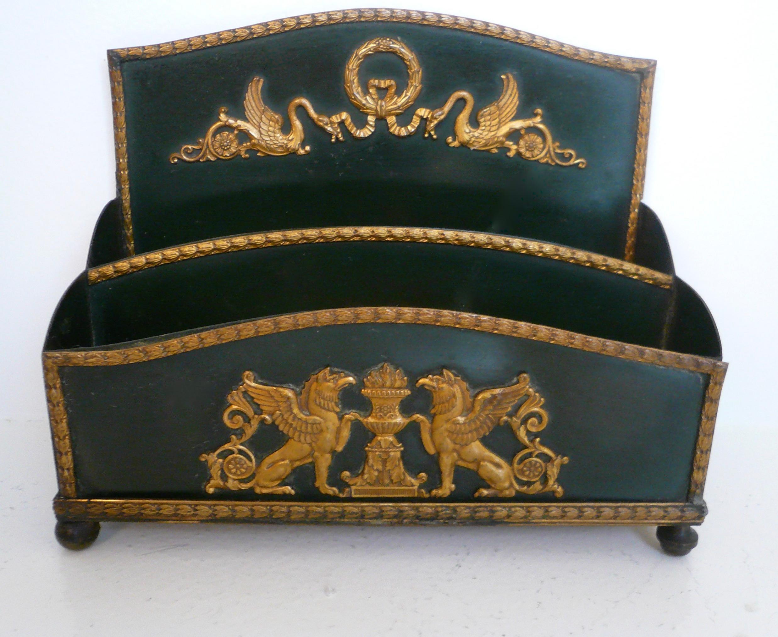 This neoclassical style bronze stationary holder would be a handsome addition to any desk. It features gilt bronze Empire style motifs including swans, wreaths, and urns.