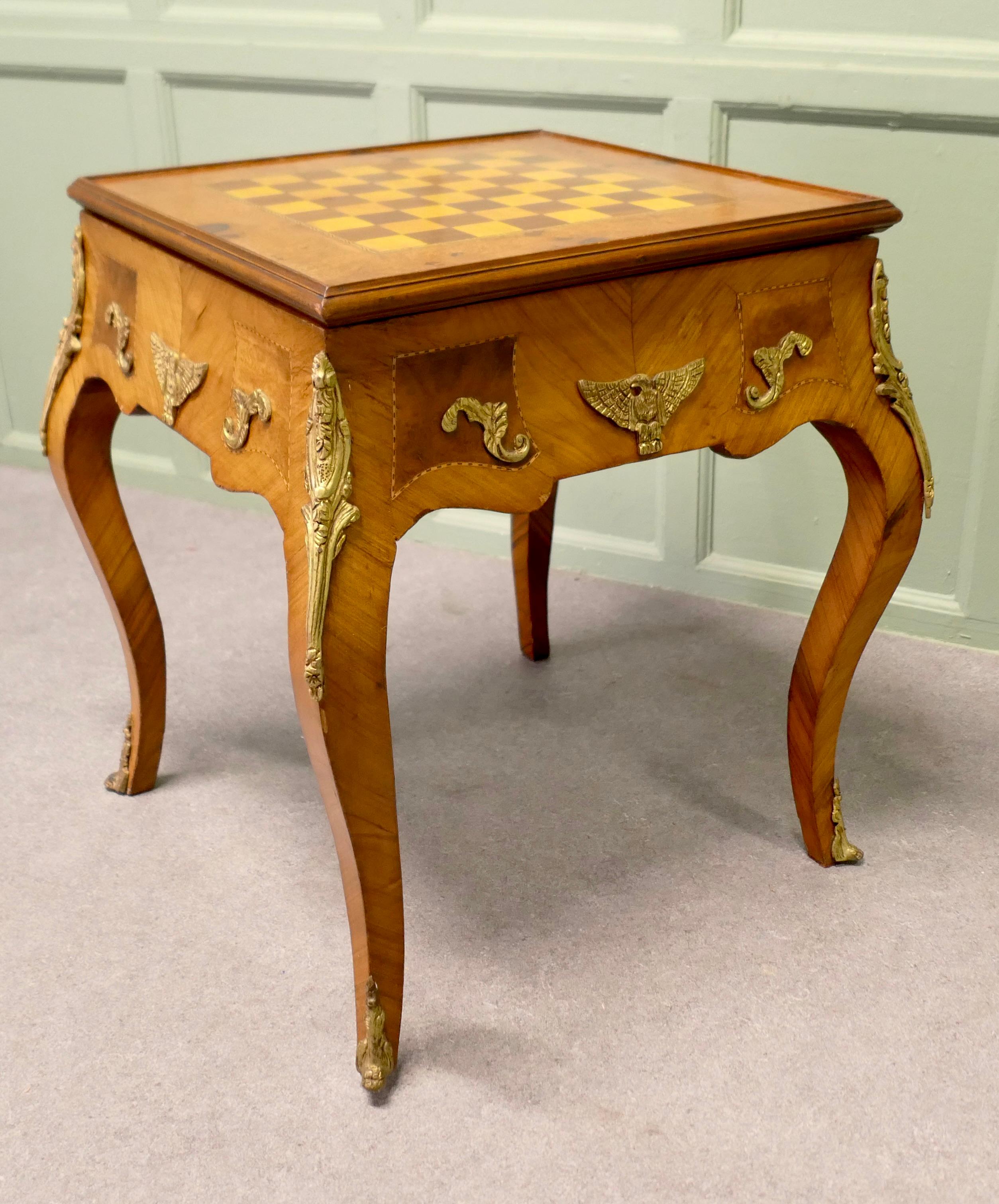 French Empire Style Burr Walnut and Ormolu Games Table, Chess and Backgammon

This is a charming piece, the table stands on bombe style cabriole legs and has ormolu decoration in the Egyptian style
The top simply flips over and becomes a very