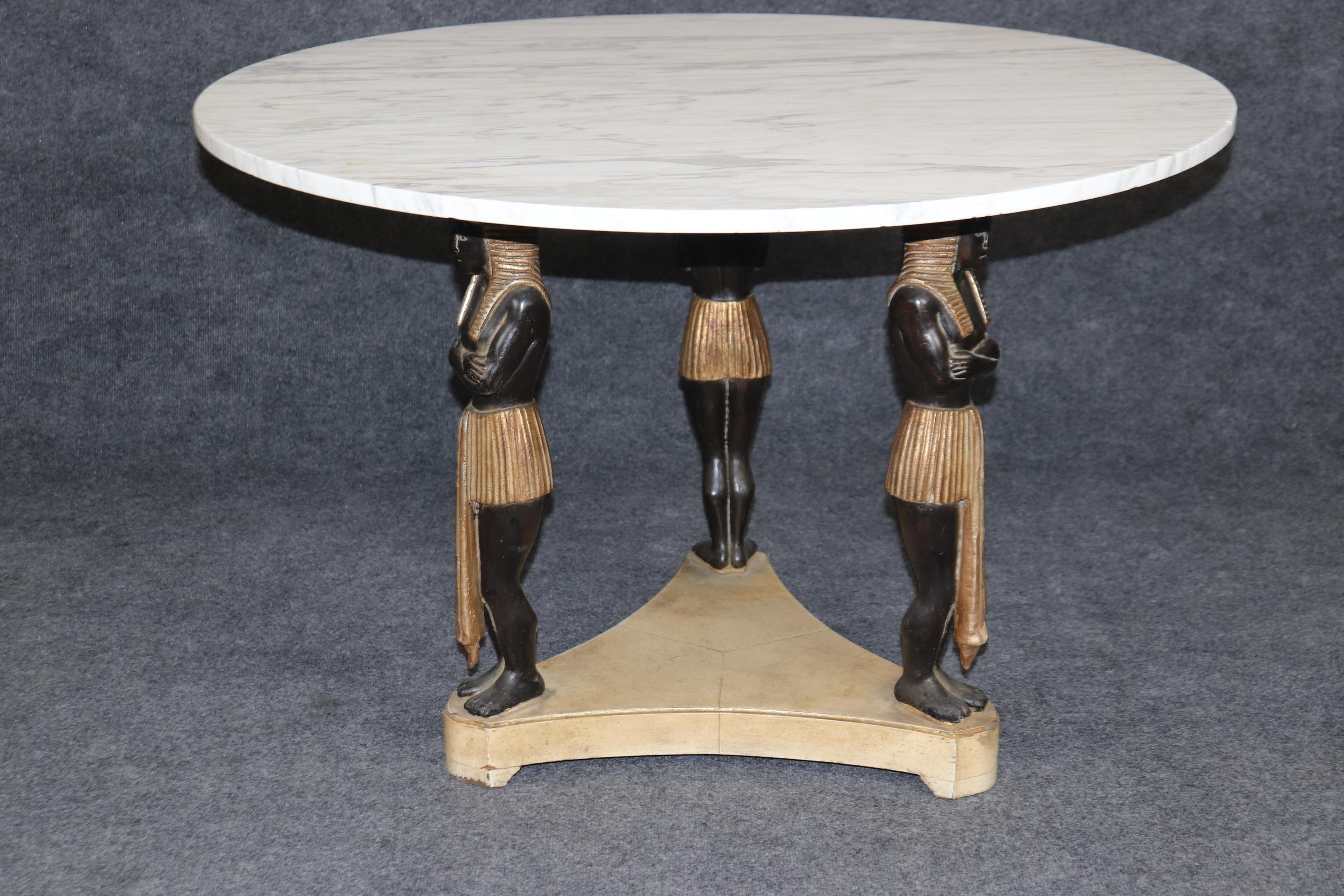 Dimensions: Height: 27 in Width: 40 in Depth: 40 in 
This vintage French Empire style carved figural marble top coffee table/center table is of the highest quality! If you look at the photos provided, you can see the attention to detail in the