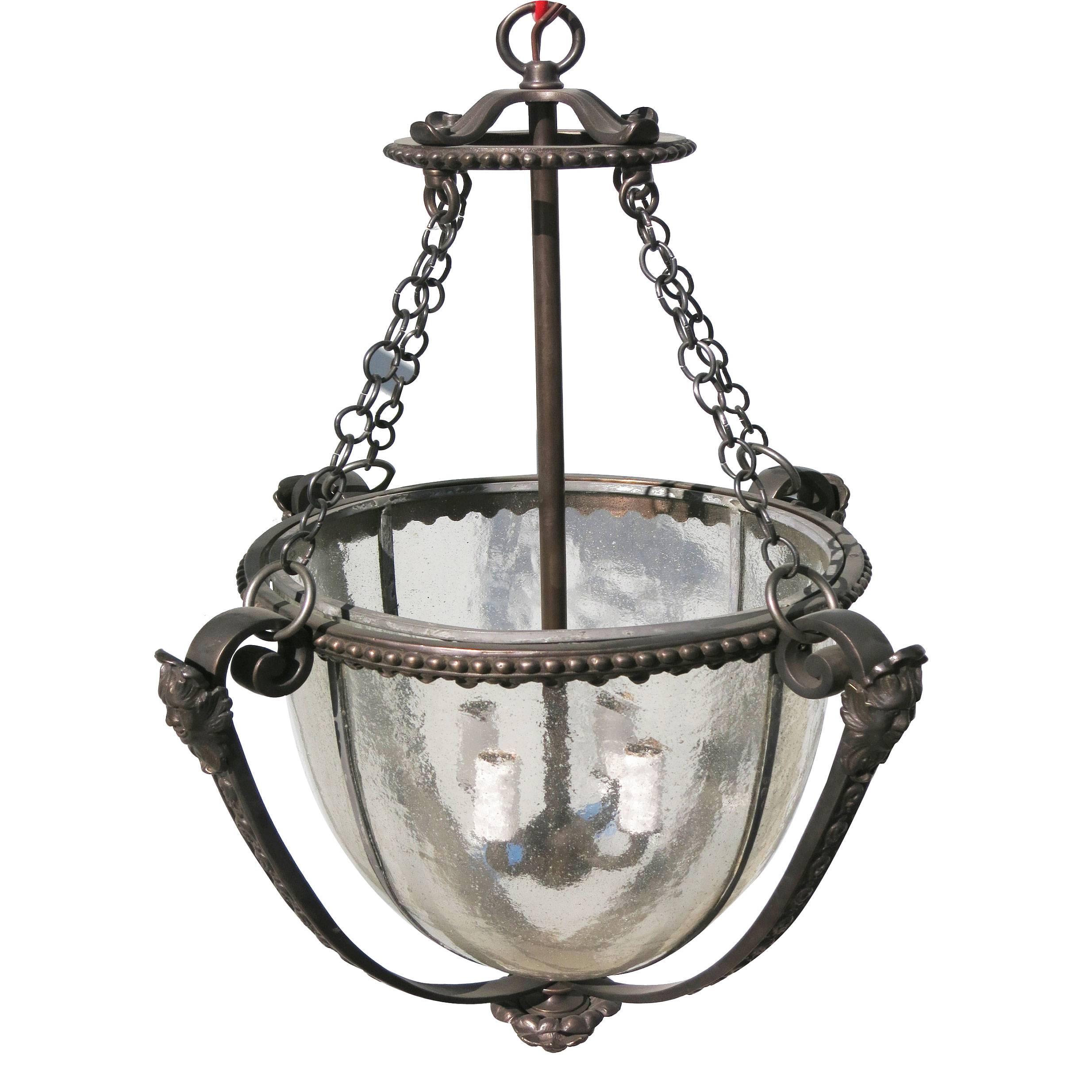 Bronze lantern with faces and blown glass shades with a three-light cluster body, late 1890s style.

Available- 3.

addx1.