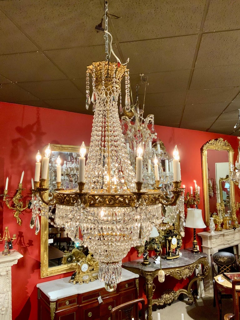 This French empire style chandelier has three interior lights and ten
Lights around the outer perimeter. The crystal is clean and brilliant and
Is sure to add a special sparkle to your room. The metal is a soft
Patinated gold finish which is