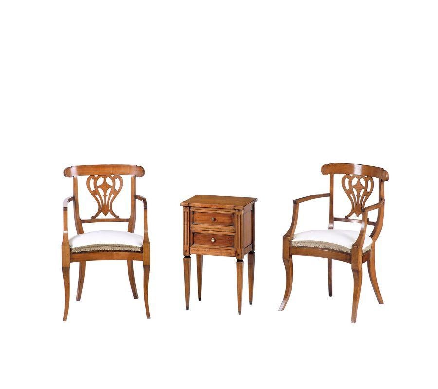 A meticulous turning process carried out by the hands of master carpenters makes this solid cherry armchair a flawless reproduction of an original French Empire piece (1804-1815). Its backrest's openwork harp-like design adds a poetic touch to its
