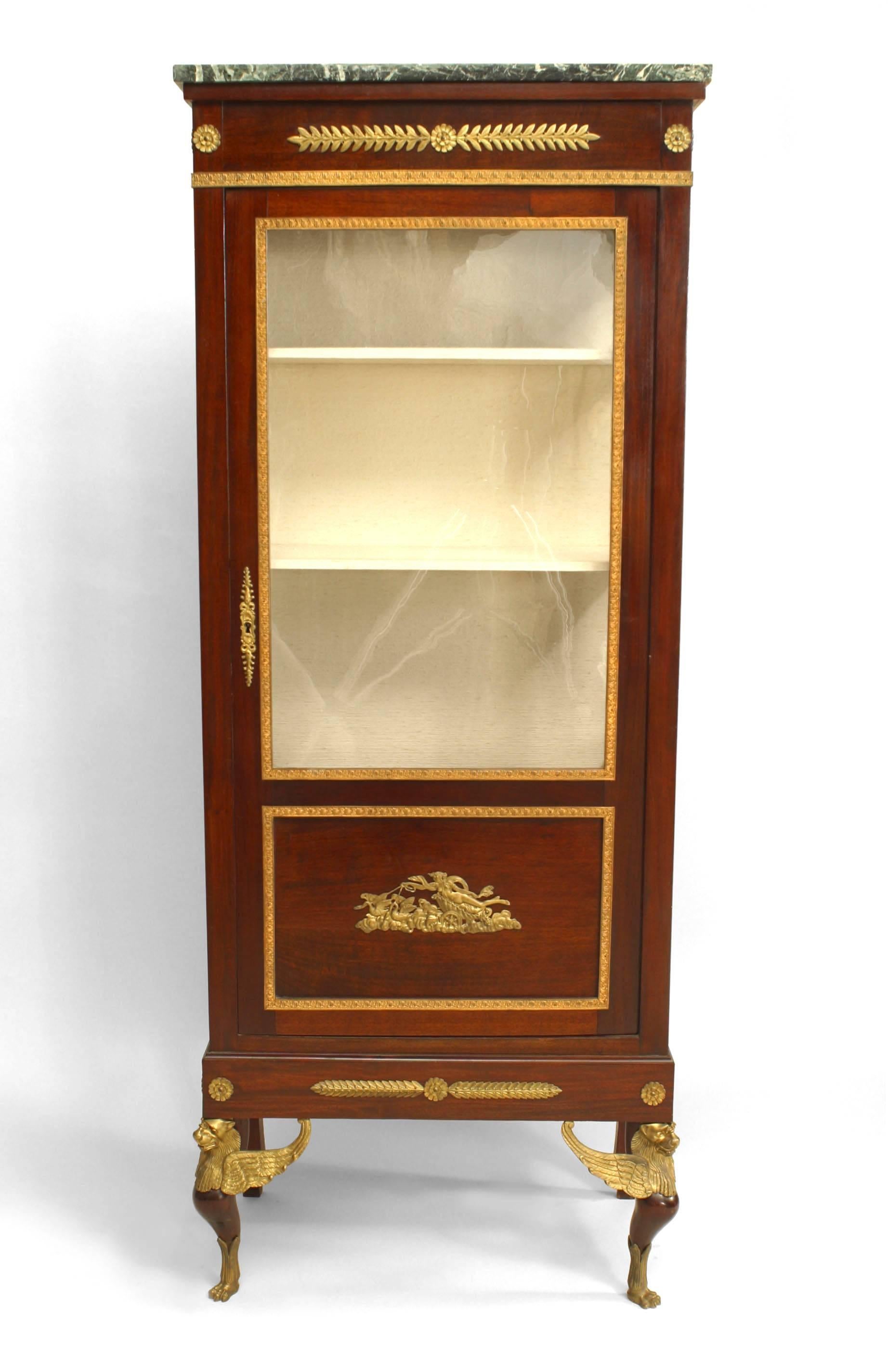 French Empire-style (19th Century) mahogany single door display/vitrine cabinet with gilt bronze trim and front sphinx form legs.
