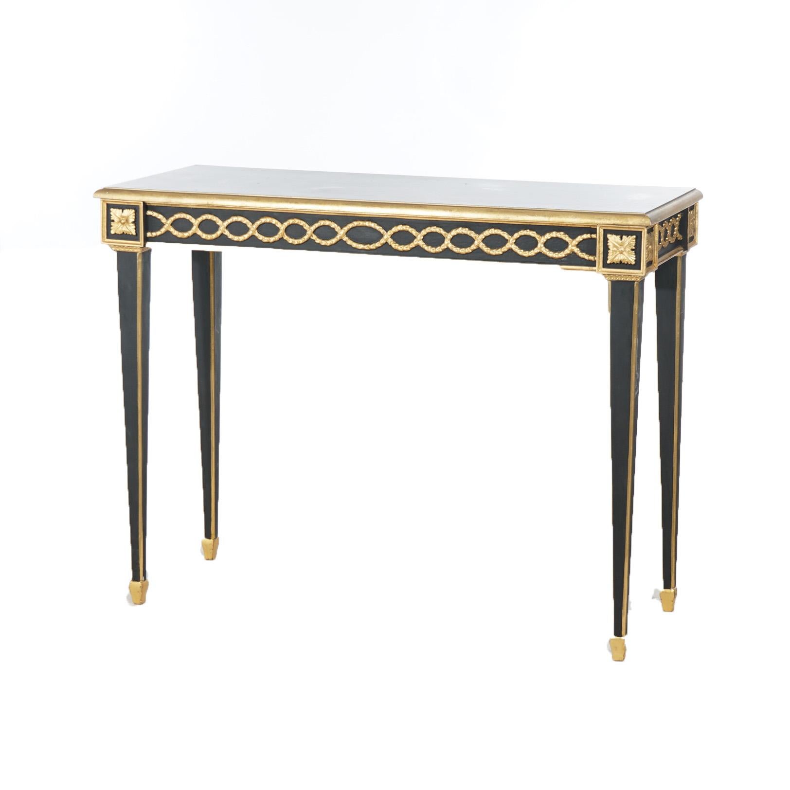 ***Ask About Reduced In-House Shipping Rates - Reliable Service & Fully Insured***
A French Empire style console table offers ebonized wood construction with gilt foliate, rosette and pinstripe highlights, raised on square and tapered legs, 20th