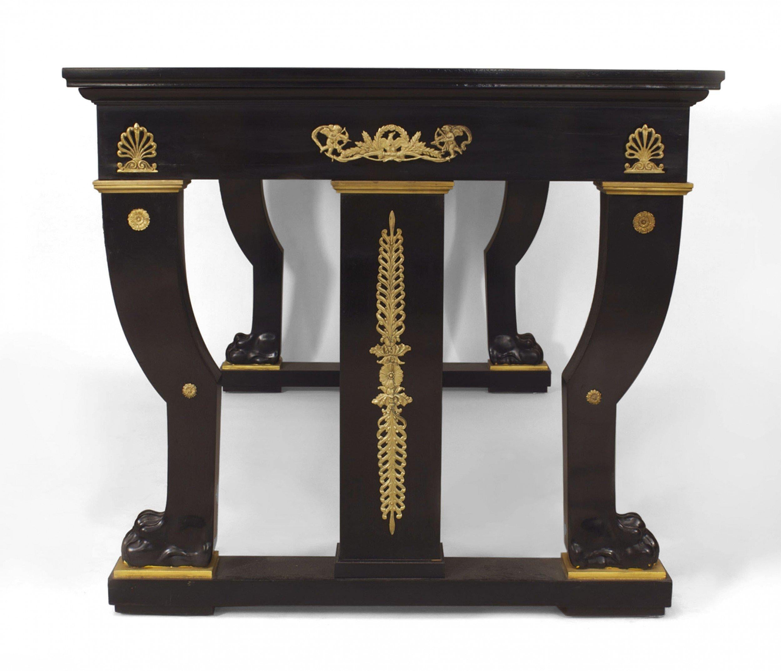 French Empire style (19th Century) ebonized mahogany writing table desk with a leather top & claw feet resting on a platform base. (after JACOB DESMALTER at Fonteainbleau Palace).