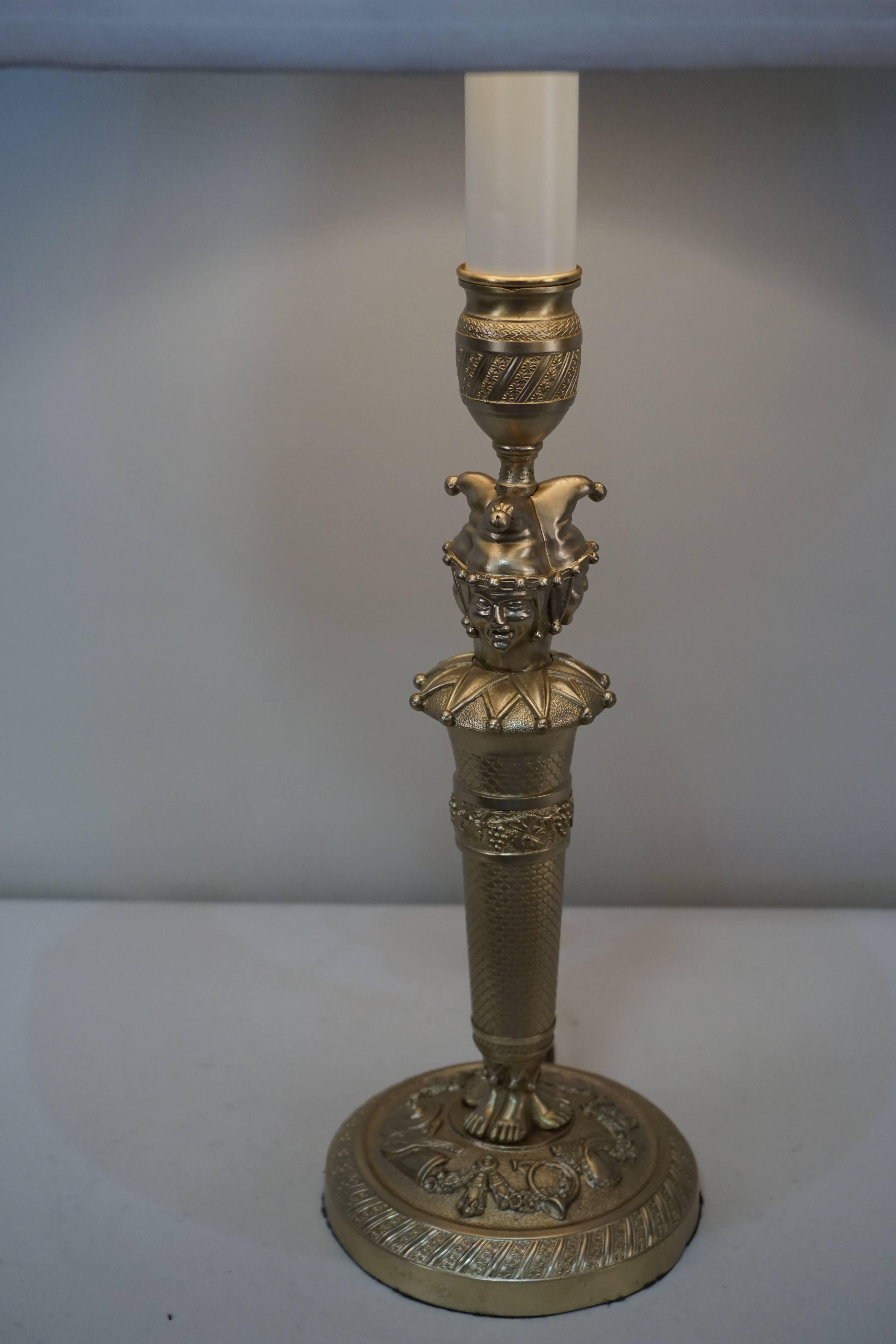 French early 20th century bronze candlestick that has been electrified and fitted with box pleated silk lampshade.