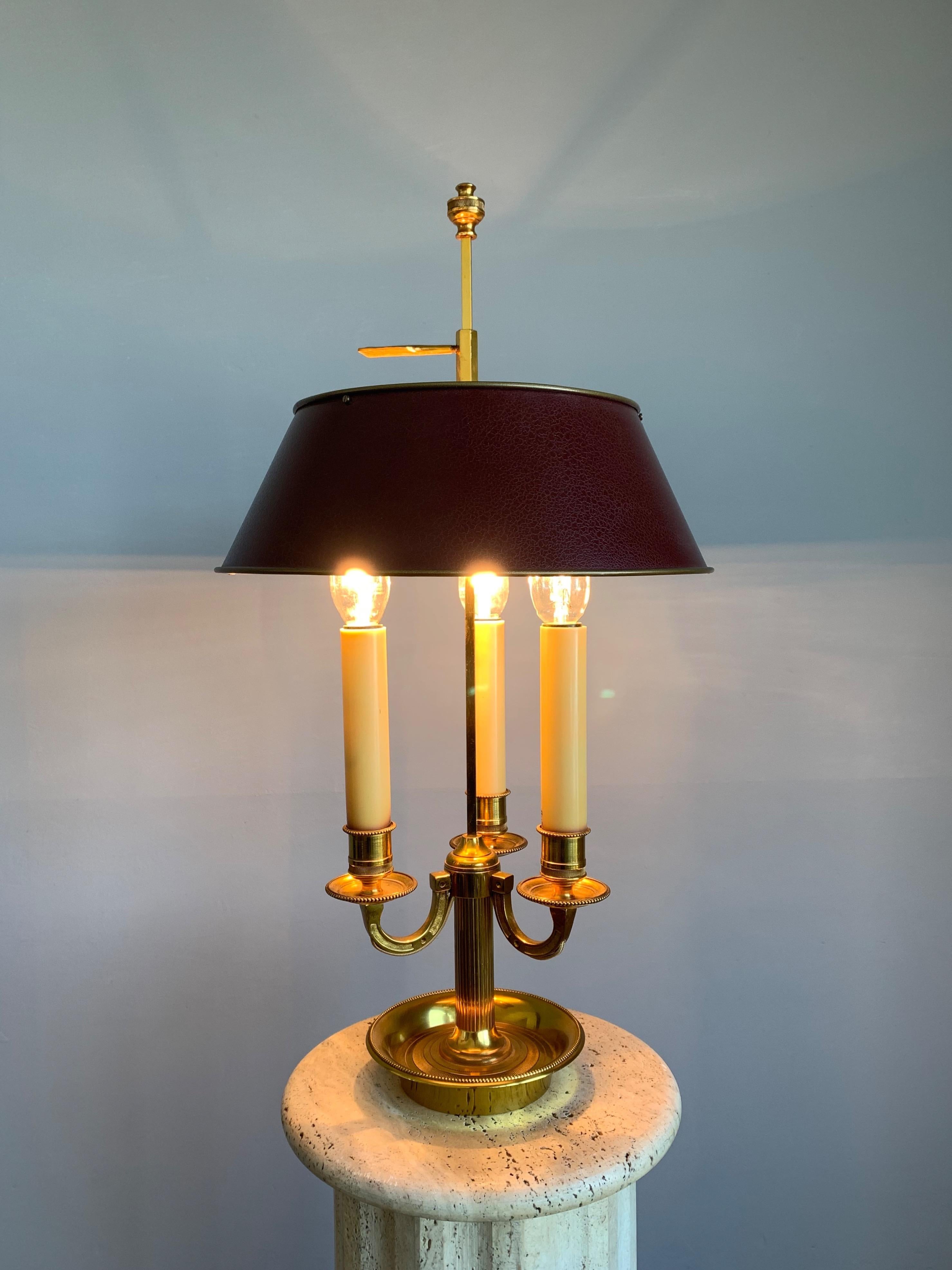 Stylish and mint condition Empire Revival table lamp. 

This 1970s table lamp was created in Paris, France and it is perfect for bringing warm light and a good atmosphere to your home or office interior. The beautifully shaped, metal lamp shade is