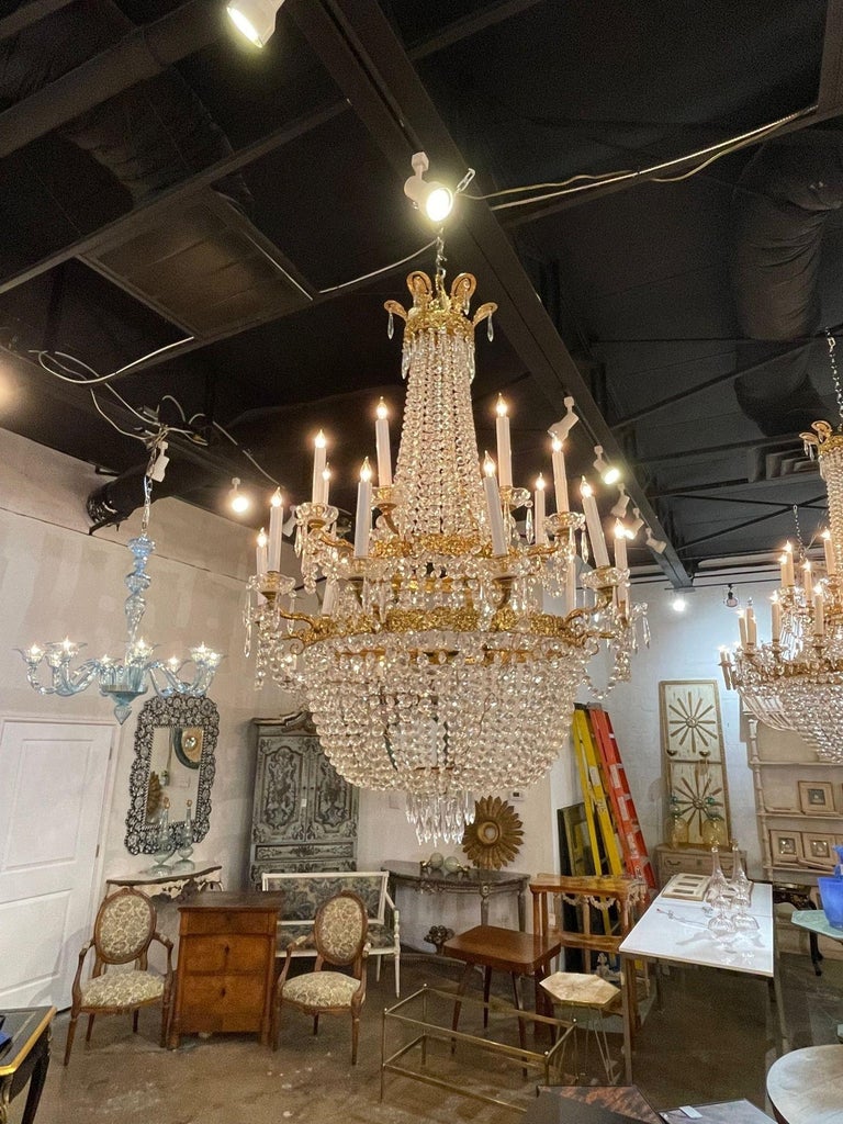 Very fine vintage large scale French Empire style gilt brass and crystal basket form chandelier. Featuring gorgeous shimmering crystals and 2 tiers of lights. So impressive! Stunning!