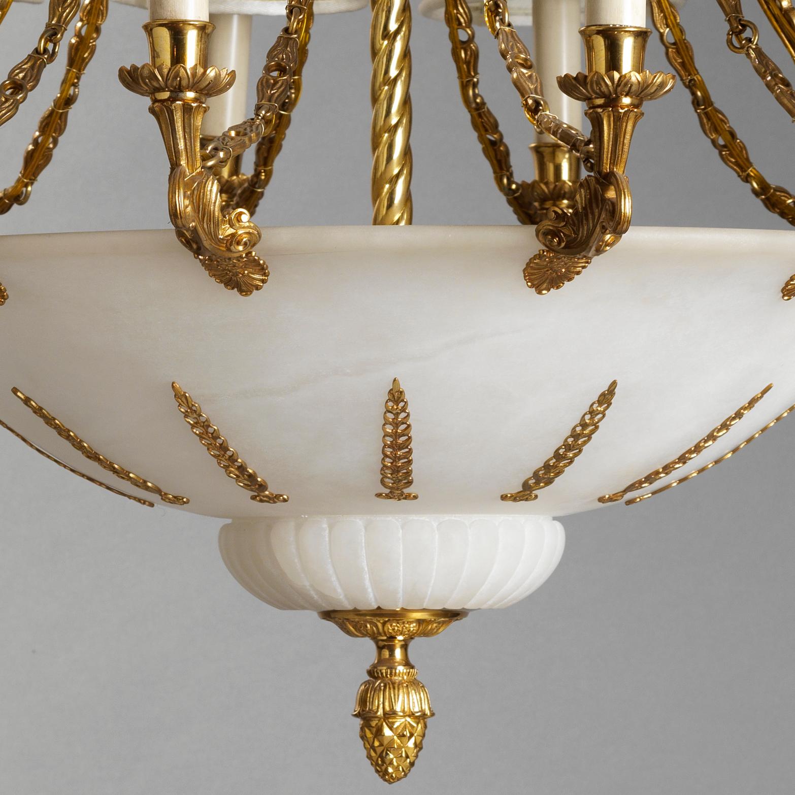 This French Empire Style Gilt Bronze and Alabaster Chandelier by Gherardo Degli Albizzi features best quality hand-chiseled details.
Top crowns in characterized by rich vegetal decoration with acanthus leaves acroterion and alabaster. Below a