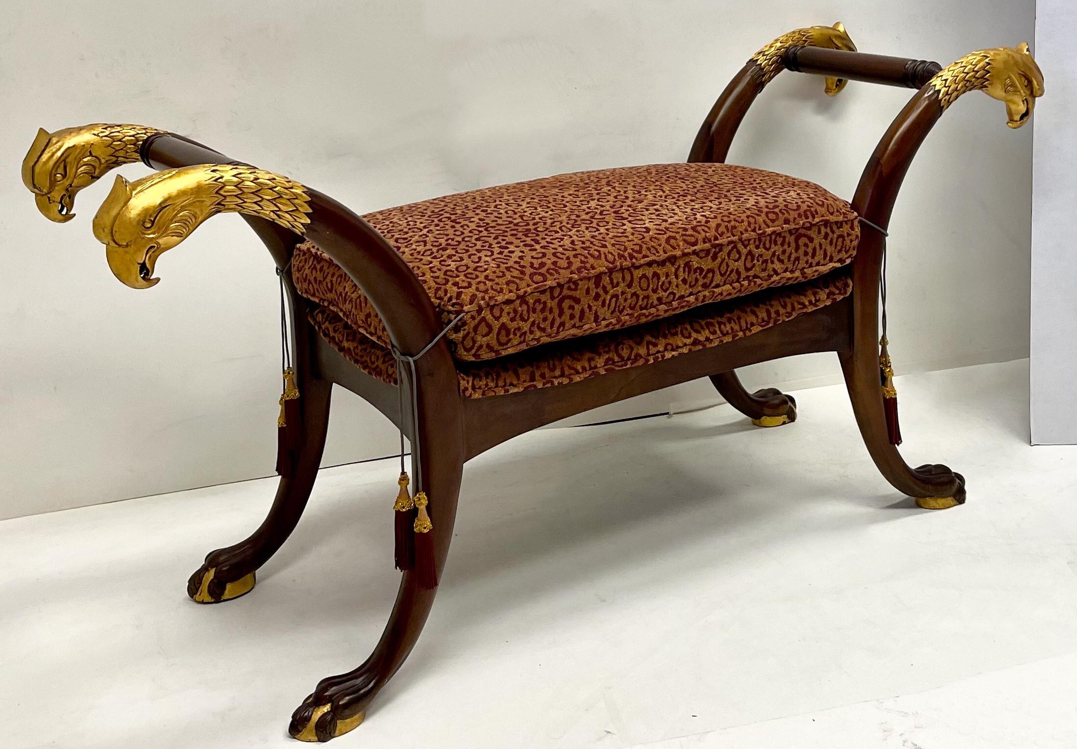 This is a late 20th century French Empire style mahogany bench with gilt eagle and paw accents. It has vintage leopard upholstery. It is in very good condition.