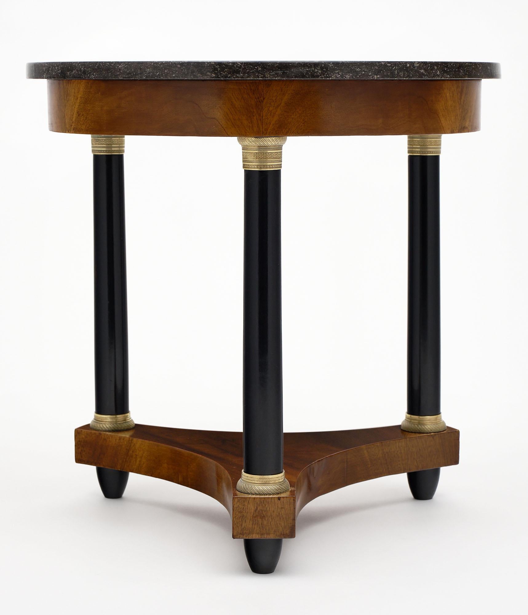 French Empire style gueridon made of mahogany and finished with a lustrous French polish. We love the Saint-Anne marble top and the three ebonized legs with finely cast bronzes. This piece brings Classic French style!