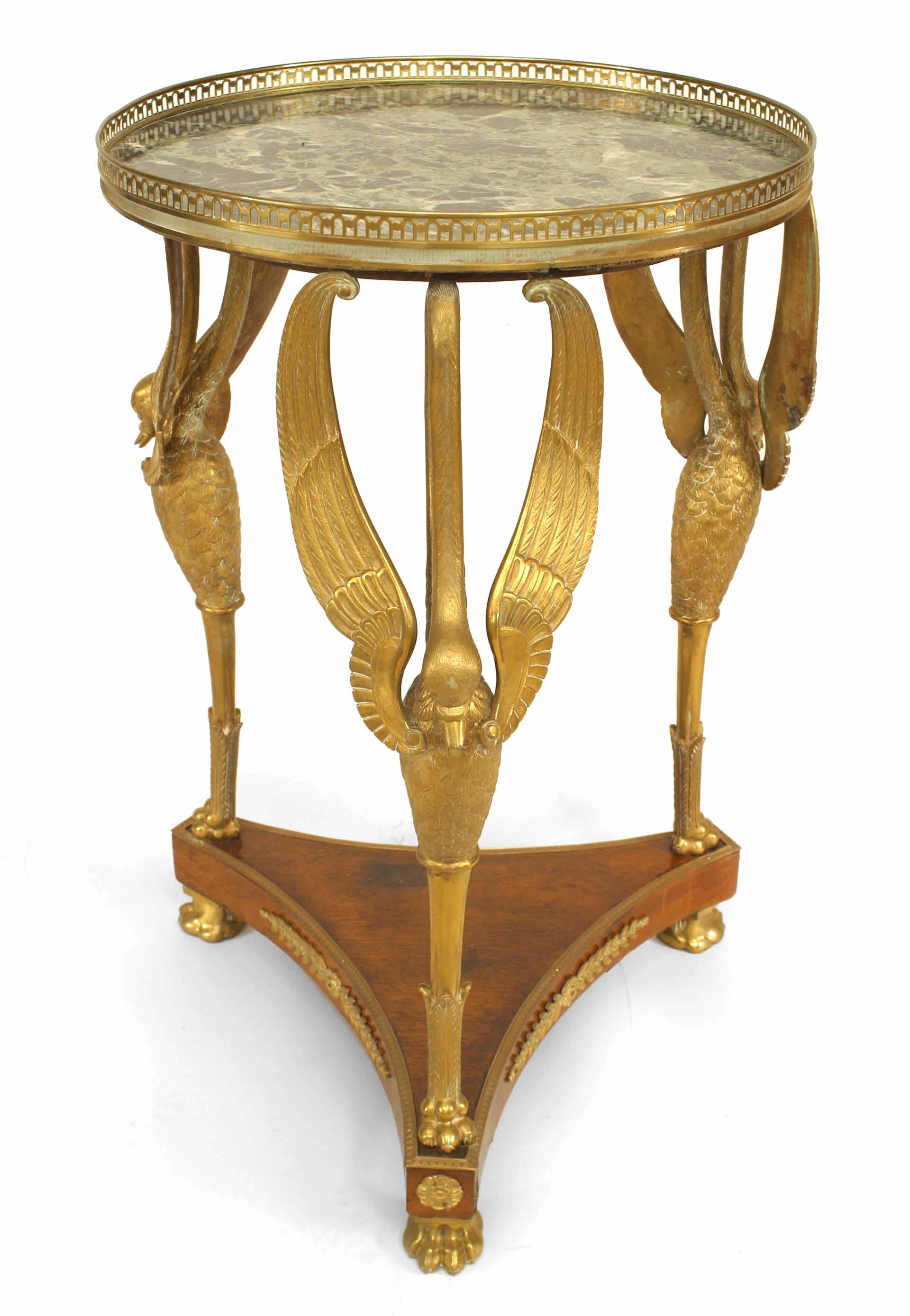French Empire-style (19th Century) mahogany and bronze gu√©ridon table on triple swan leg platform with stretcher, gallery, and green marble top.
