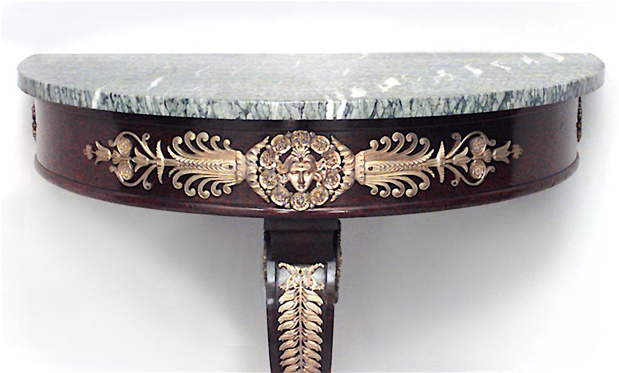 French Empire style mahogany half round bracket console table with bronze doré trim and green marble top, 19th century.
 