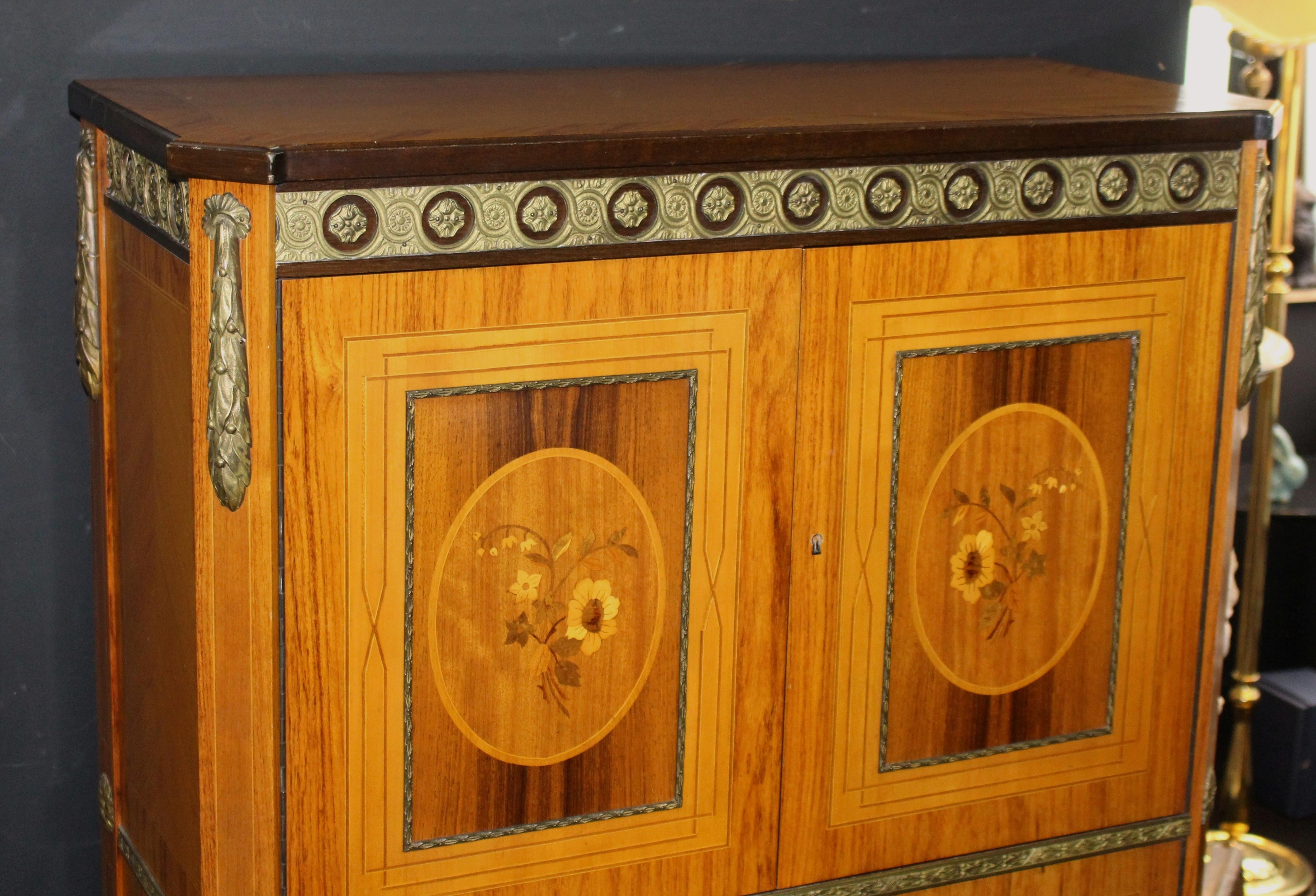 Measures: Width 89 cm 35 in
Depth 38.5 cm 15 1/4 in
Height 140 cm 55 in





Cocktail cabinet
Style French Empire style, late 20th century.
Decoration heavy inlaid with ormolu mounts
Condition very good condition commensurate with age.