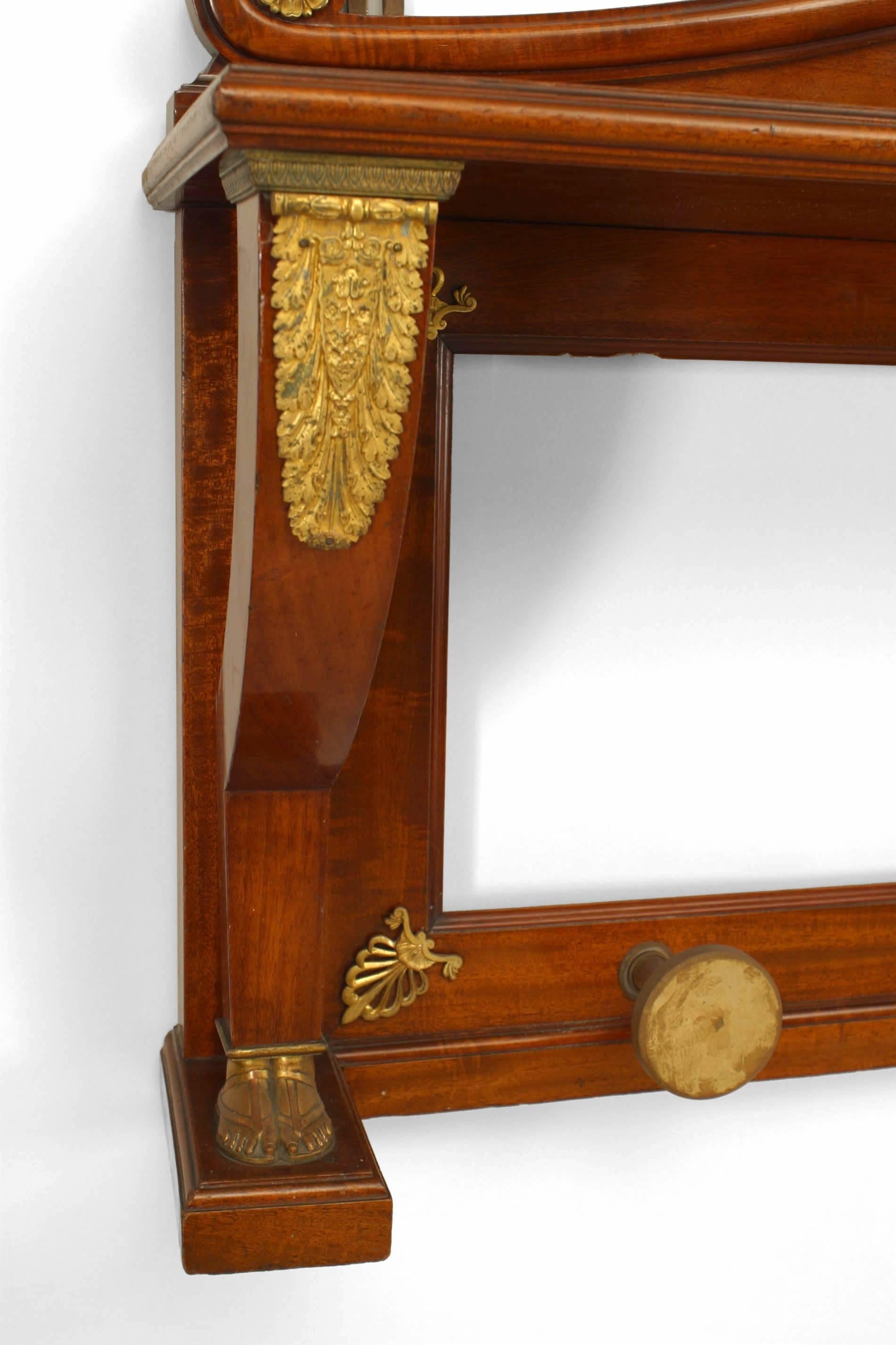 French Empire style horizontal mahogany and bronze trimmed wall hatrack with mirror under a shelf (19th Century).
 