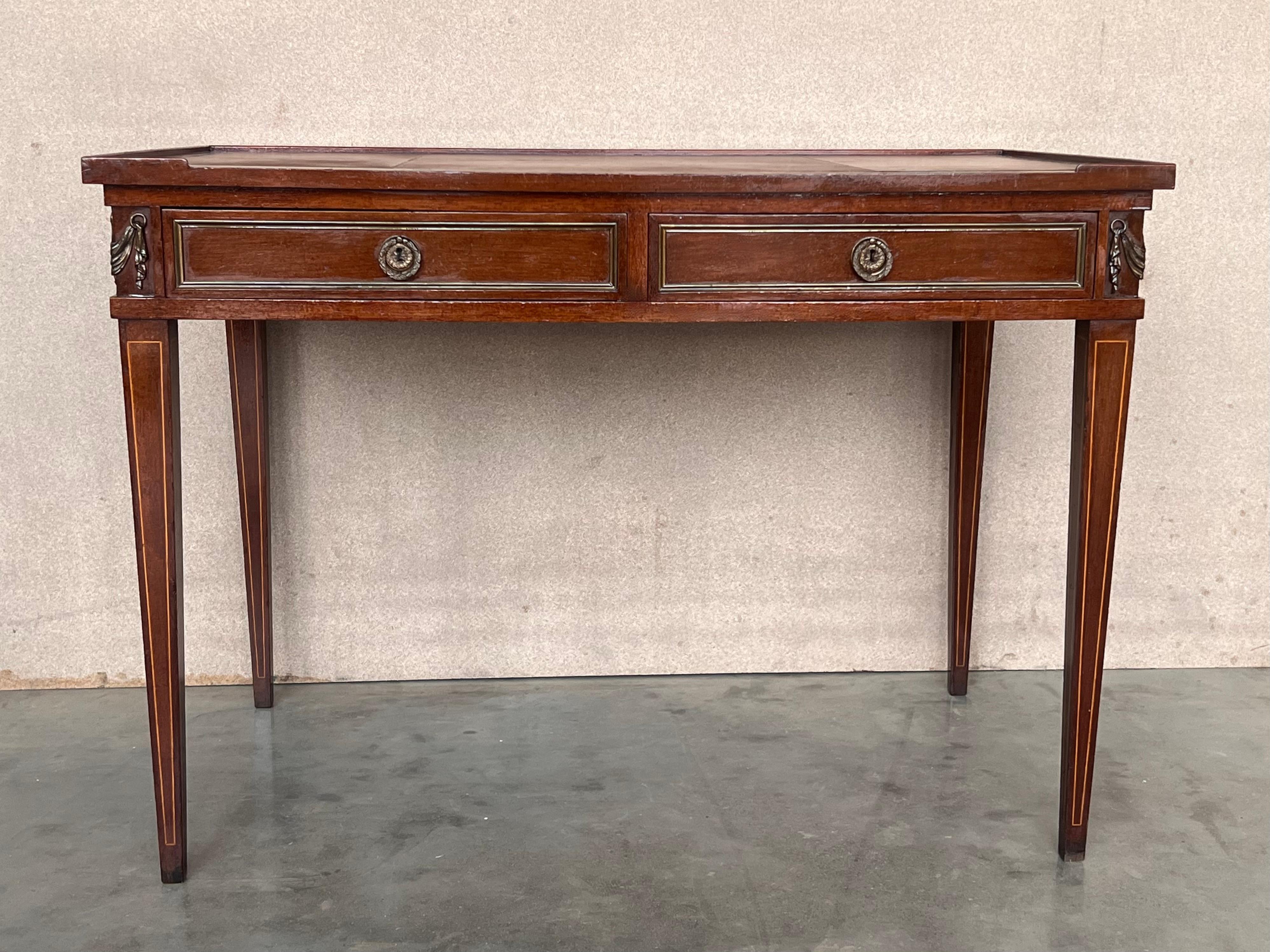 A French Empire style mahogany bronze mounted writing desk with leather top, circa 1940.