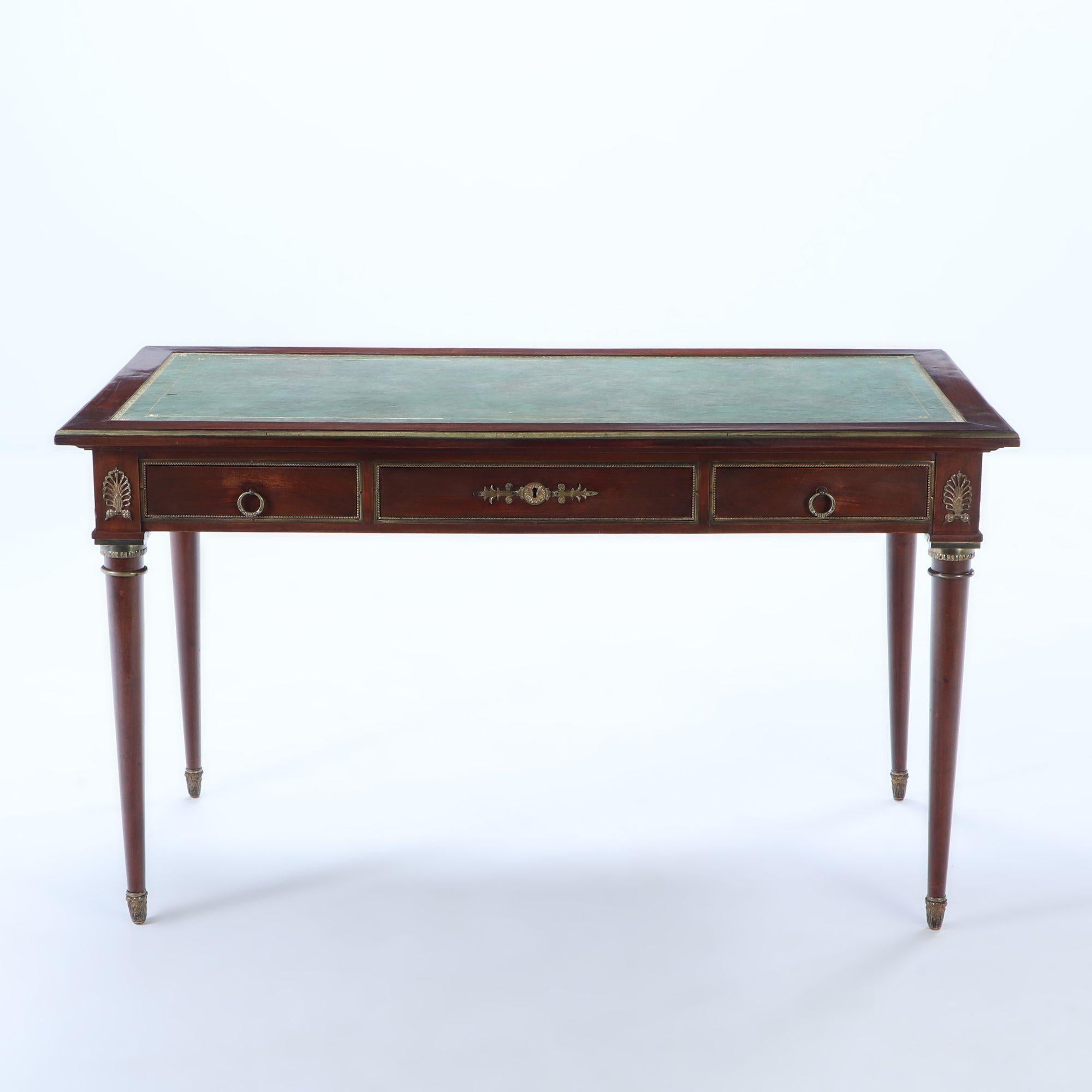 A French Empire style mahogany bronze mounted writing desk with leather top, circa 1940.