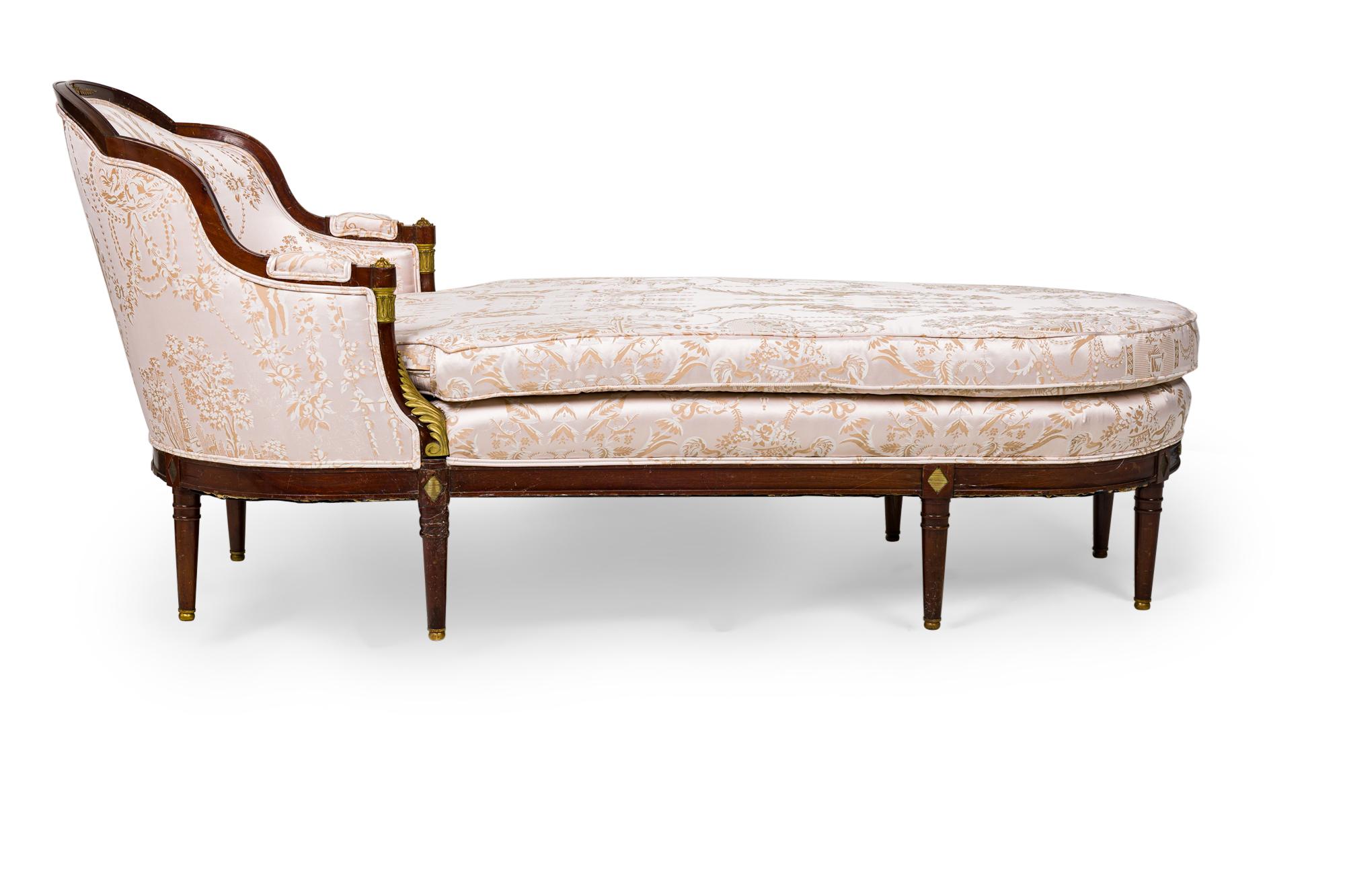 French Empire-style (19th Century) mahogany chaise with bronze trim and large pink and gold cushion upholstery
