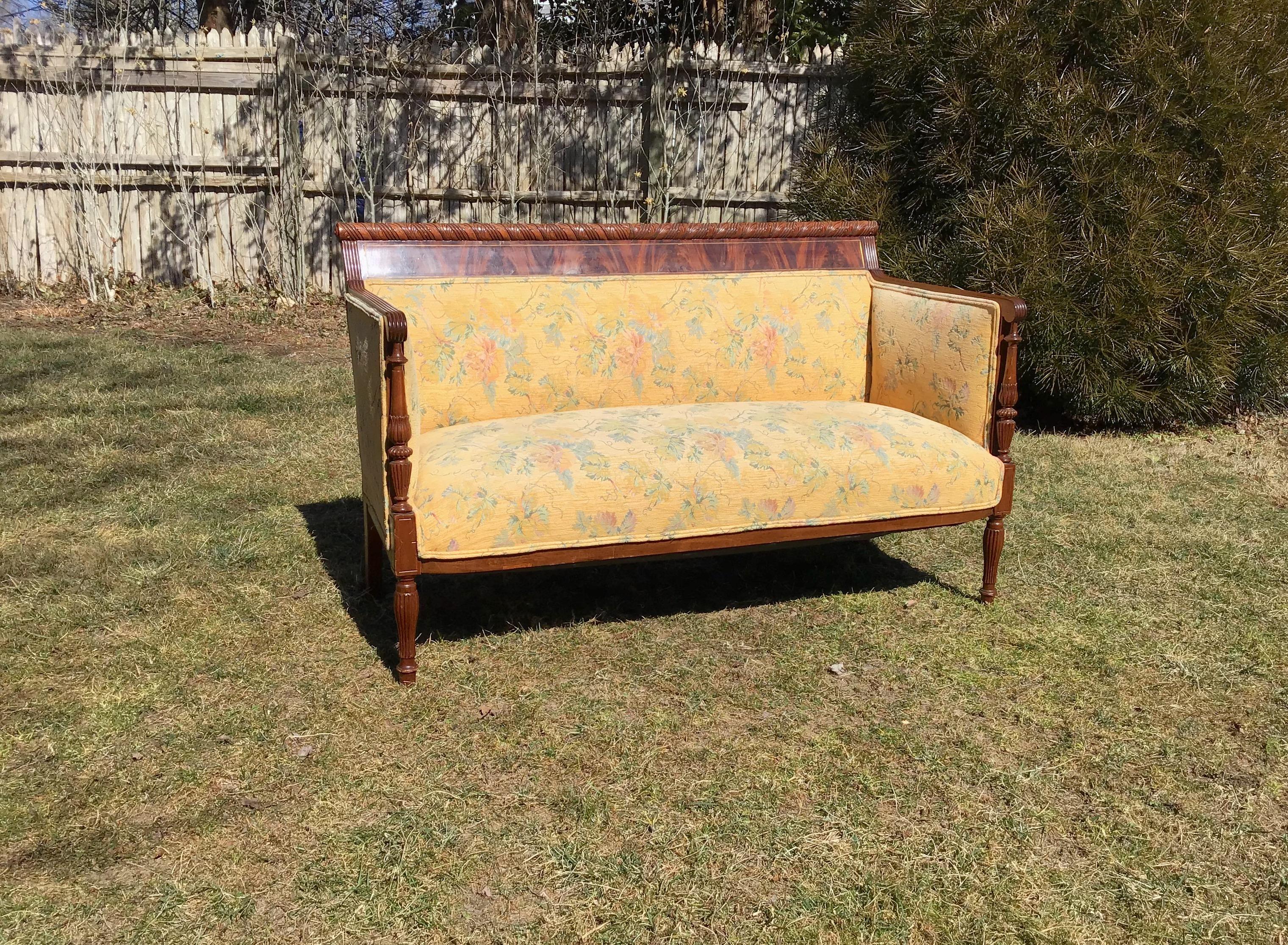 This Empire mahogany settee is in the French empire style,
it is an upholstered settee, or an antique sofa settee,

Minor scratches and dings on legs mostly, and two putty repairs to back tops of edges, presumably where settee has hit wall all of