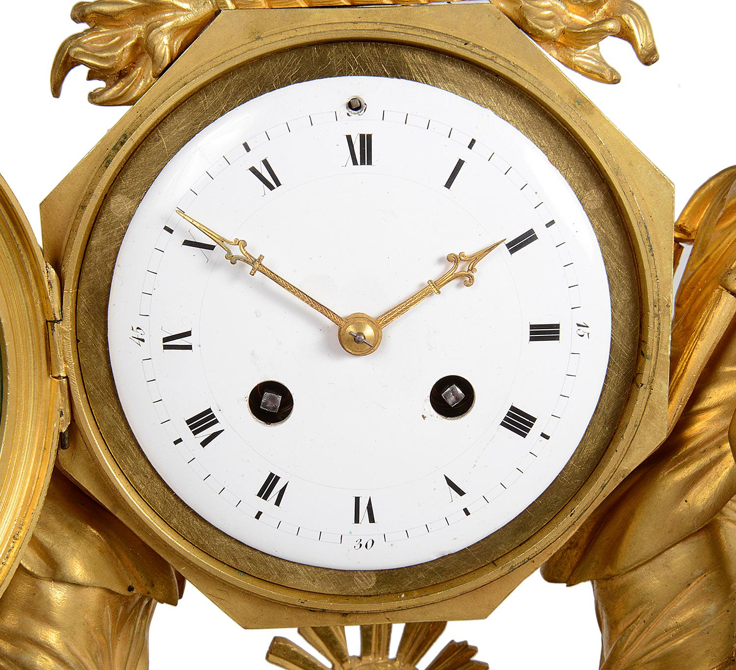 Très impressionnante et élégante horloge de manteau du début du XIXe siècle en bronze doré et marbre vert, avec deux jeunes filles classiques alimentant des béliers de part et d'autre, un aigle au-dessus de l'horloge circulaire en émail blanc, un