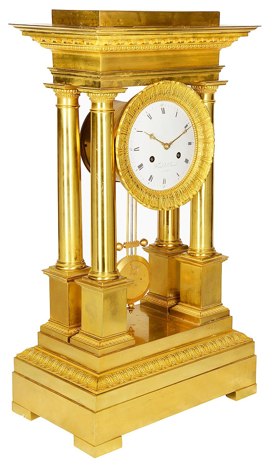 A very good quality 19th century French gilded ormolu Empire style mantel clock, having four classical column supports to the white enamel clock face with roman numerals, sticks on the hour and half hour with an eight day duration. Mounted on a