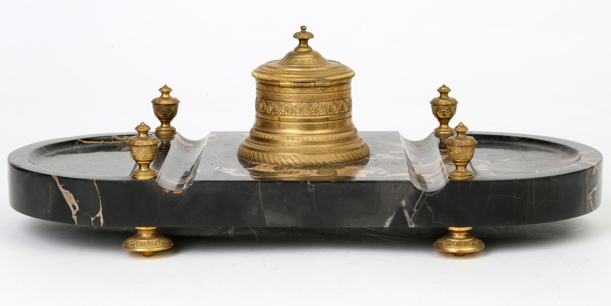 A stunning French ormolu mounted Empire style marble desk stand dating from the 19th century. This stylish stand is of rectangular shape with rounded polished ends and is made from a thick polished section of black marble with brown veining. The