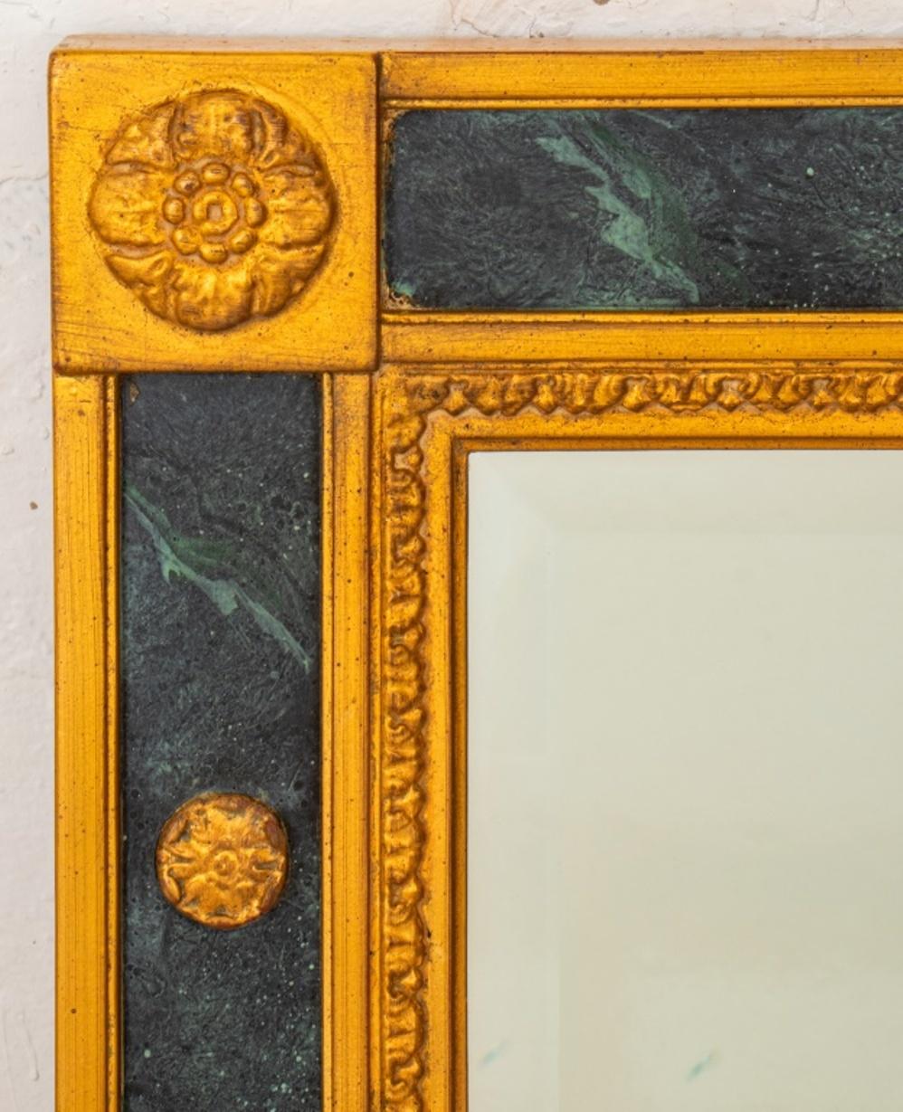 French Empire style overmantle mirror, with an egg and dart cornice on a faux marble frame encasing a beveled mirror, unmarked.

Dimensions: 39