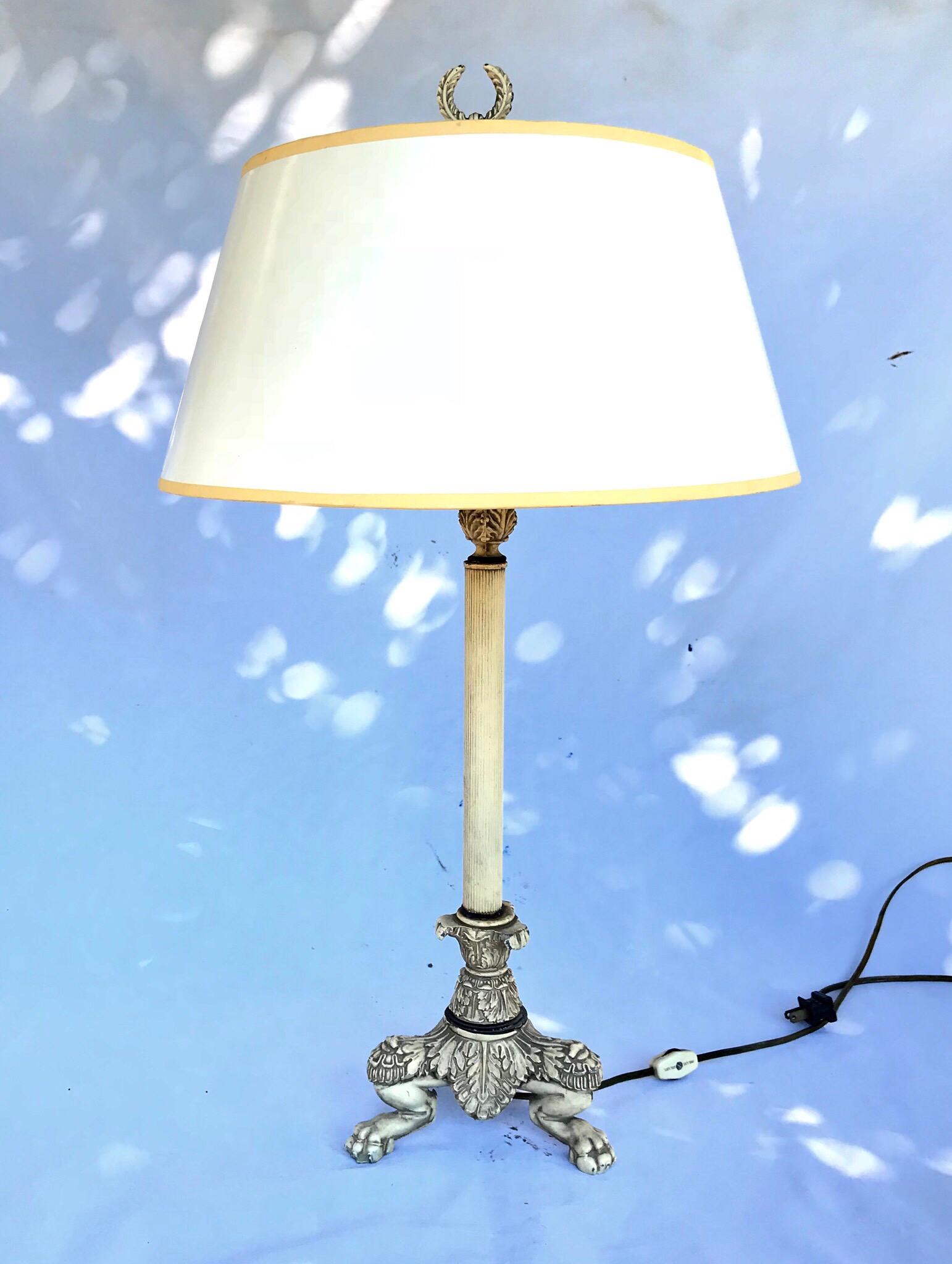 A sleek and stately table lamp in the French Empire taste by Chapman Brass. Sells with the pictured vintage white lacquered shade and original acanthus leaf finial.
 