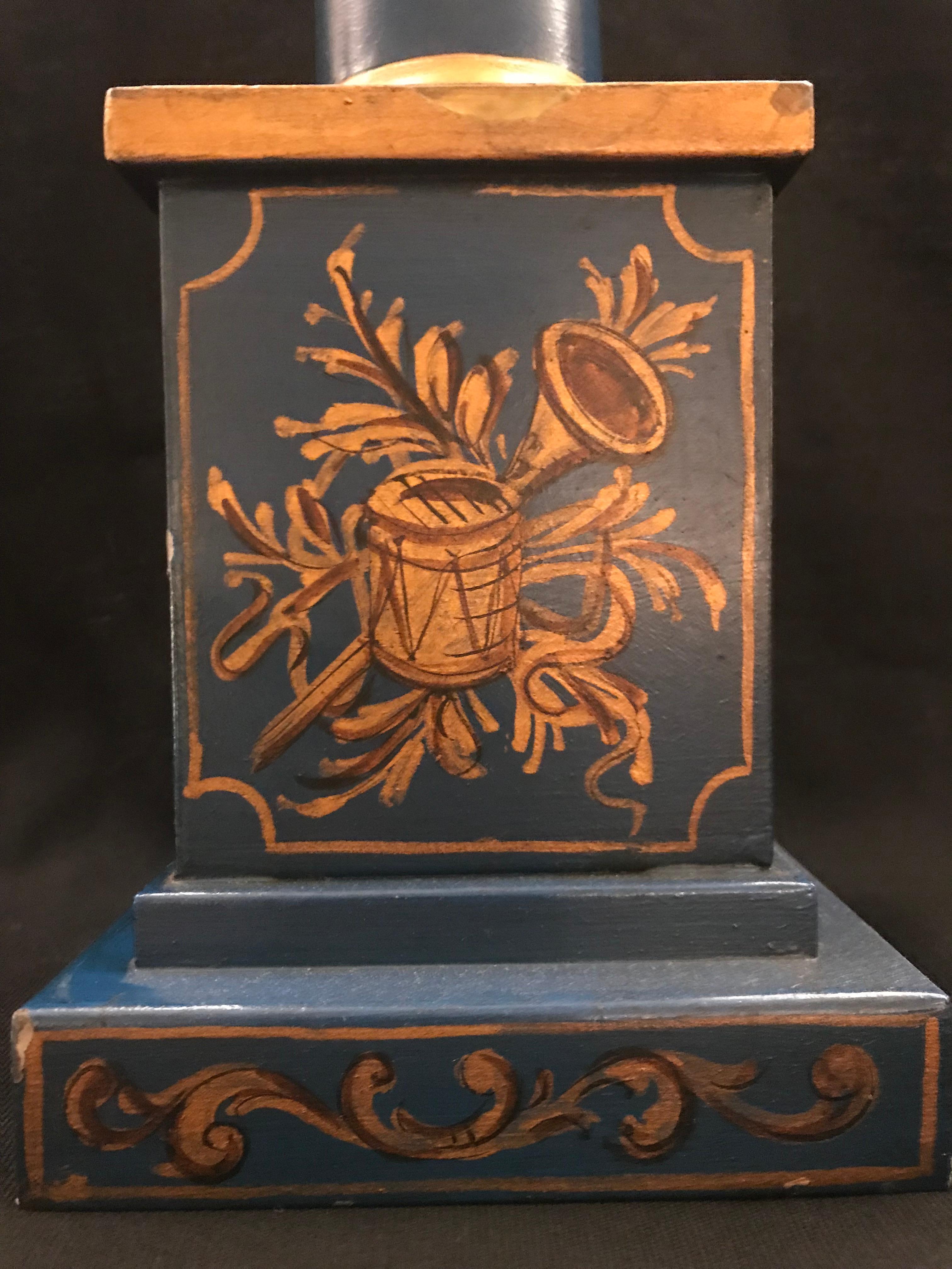 Exquisite English Regency style tole lamp By Gherardo Degli Albizzi featuring a columnar form with a round base, but is available even with a square base, with hand-painted decoration all-over the background. Hand painted wreaths adorn all around