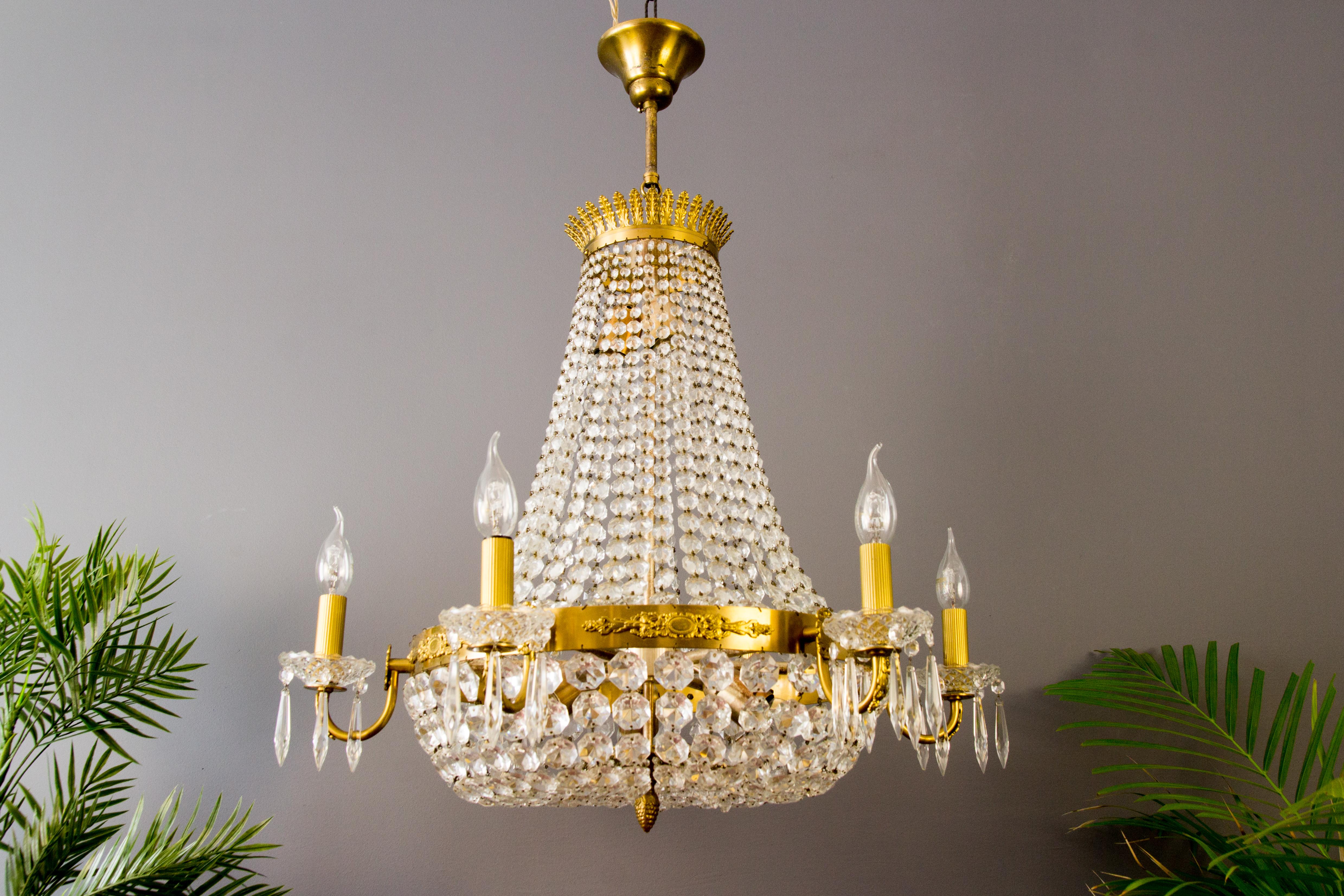 French Empire style crystal, brass, and bronze basket chandelier with six arms; brass plume castings adorn the top of the chandelier and bronze decors around the ring of the basket.
Each arm has an E14 socket with new wiring and bobeches made of